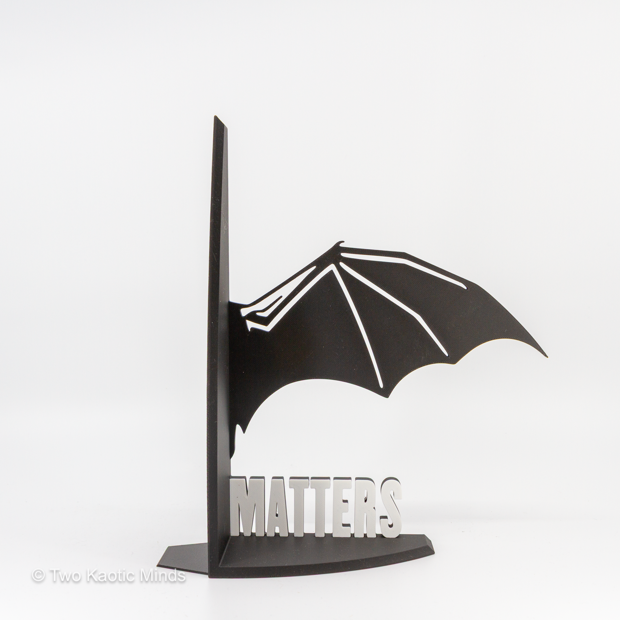 Single MATTERS dragon wing bookend in black and white shown from the front on white background