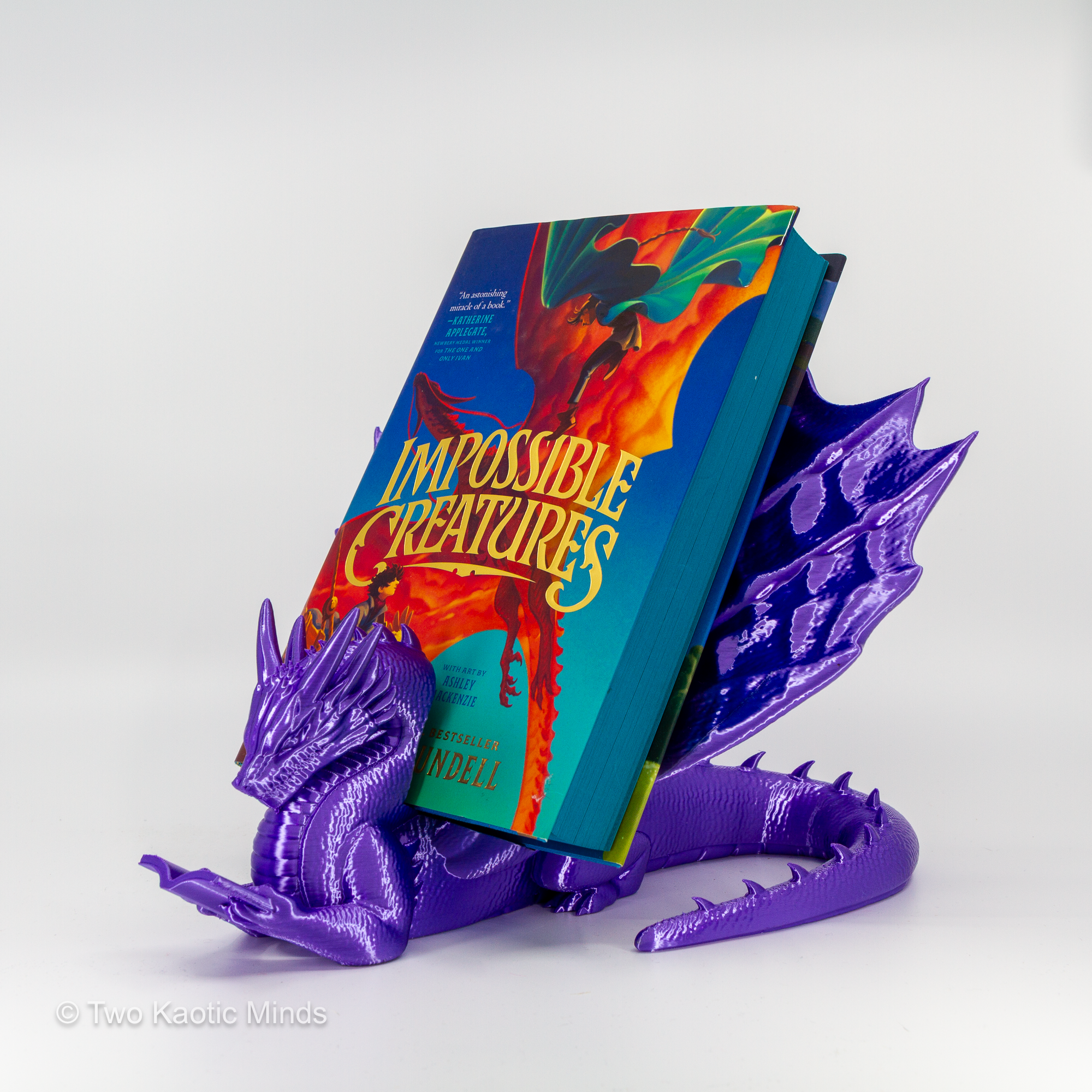 Purple dragon book holder in use with Impossible Creatures book standing upright in the slot