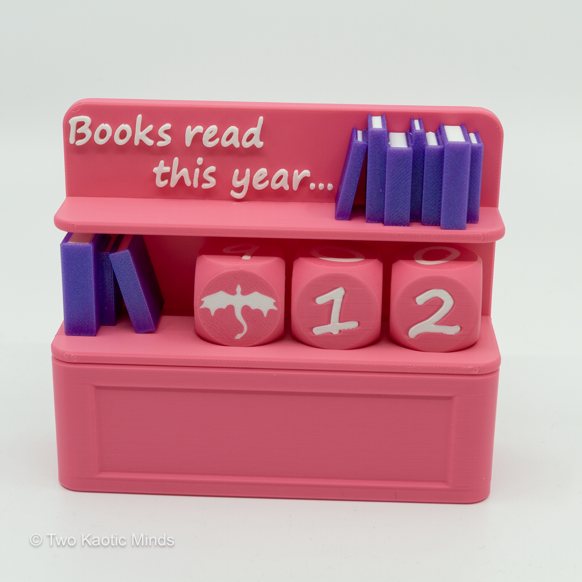 3D printed pink Book Counter shelf decor with mini books and custom dice showing numbers 1 and 2, front angle view20260216 - Book Counter_01.png