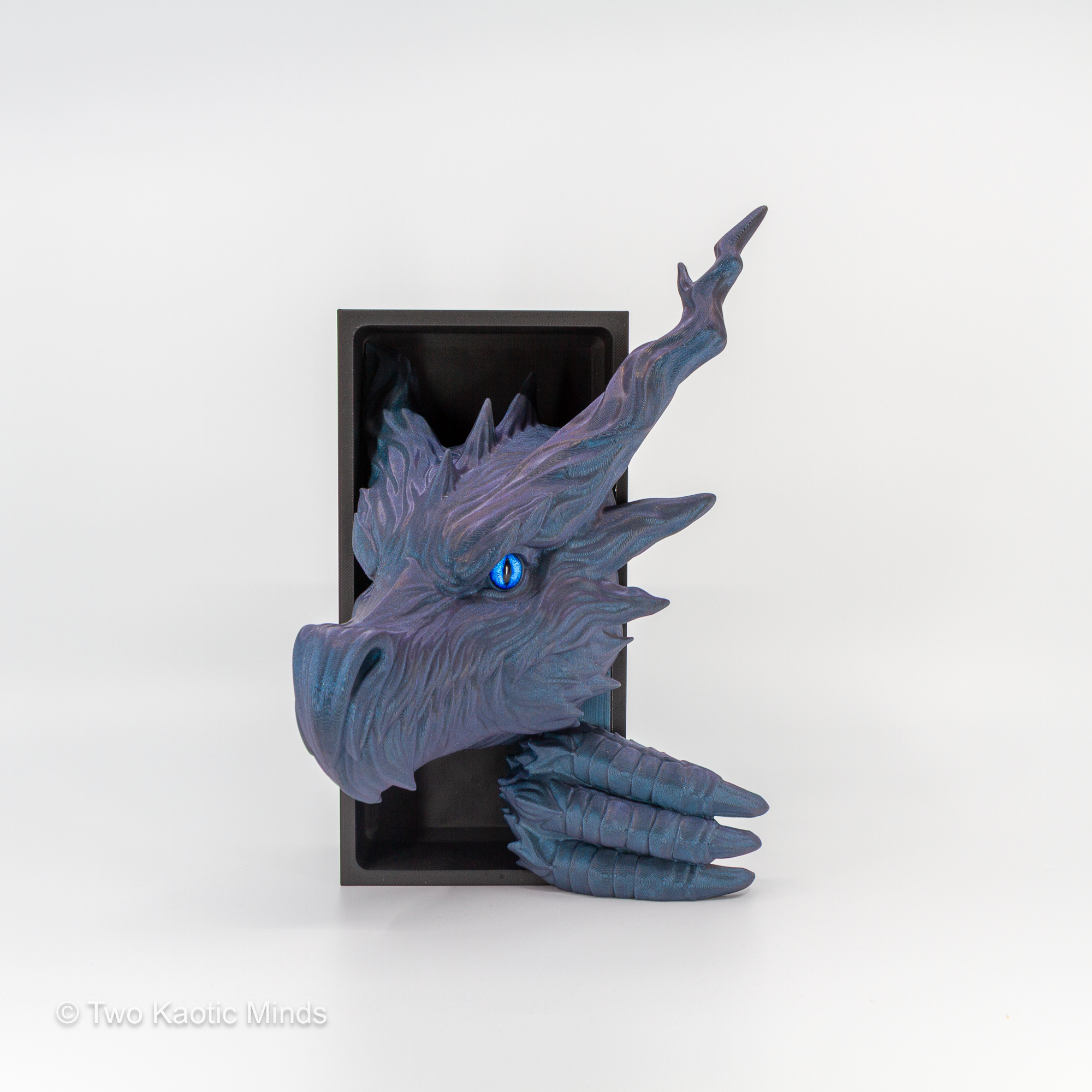 Angled front view of the Shadow Dragon book nook showing iridescent blue-purple Starlight Twilight finish, swept-back horns, feathered scale detail, and blue glass eye