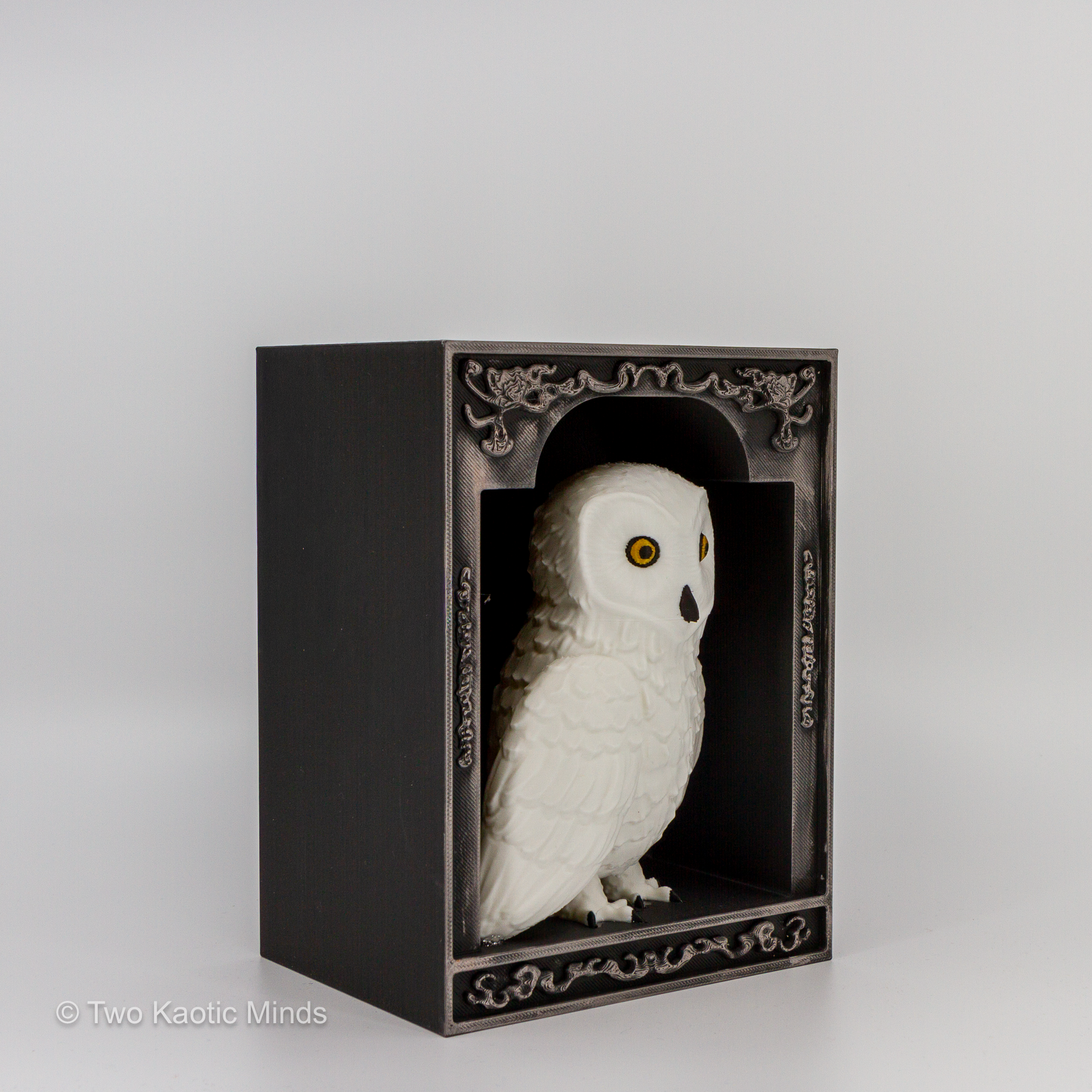 Angled front view of the owl book nook showing white snowy owl detail and pewter Rub and Buff finish on the decorative black frame border