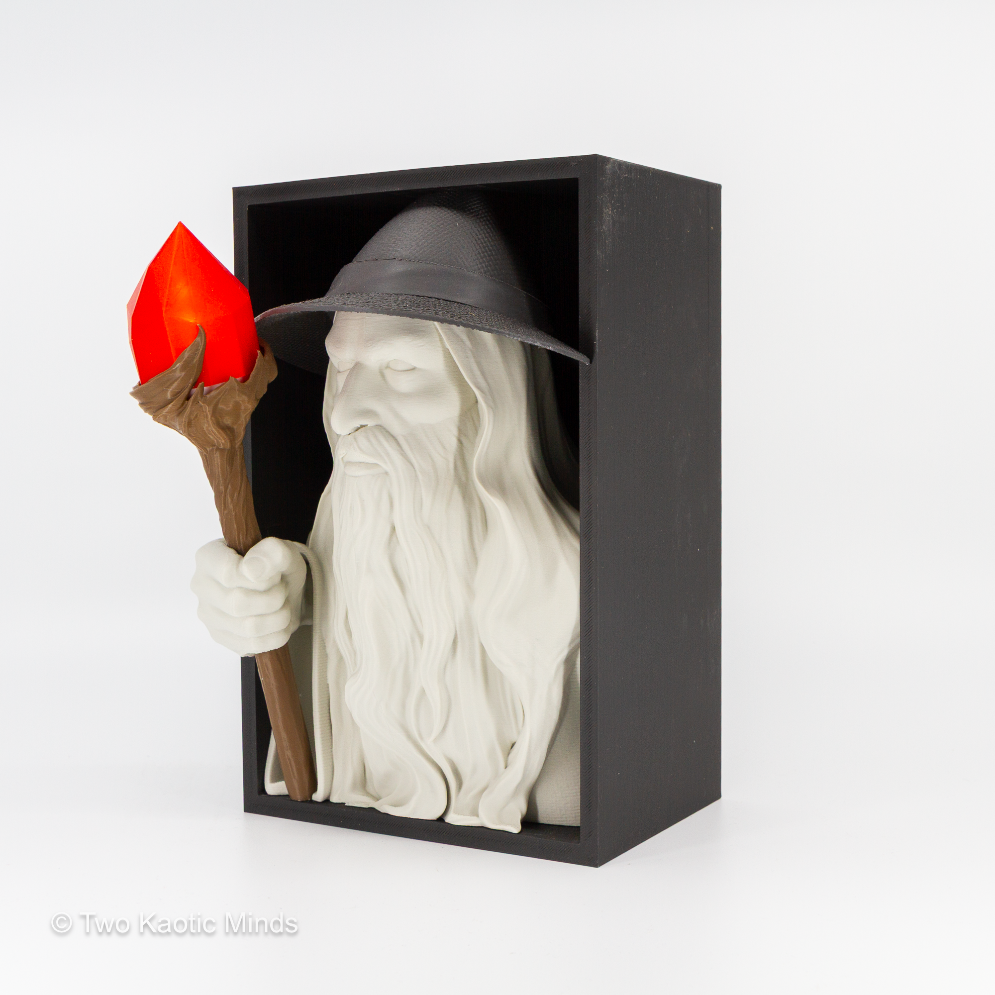 Side angle view of the LotR wizard book nook showing wizard profile with staff and glowing LED lantern against the matte black outer box
