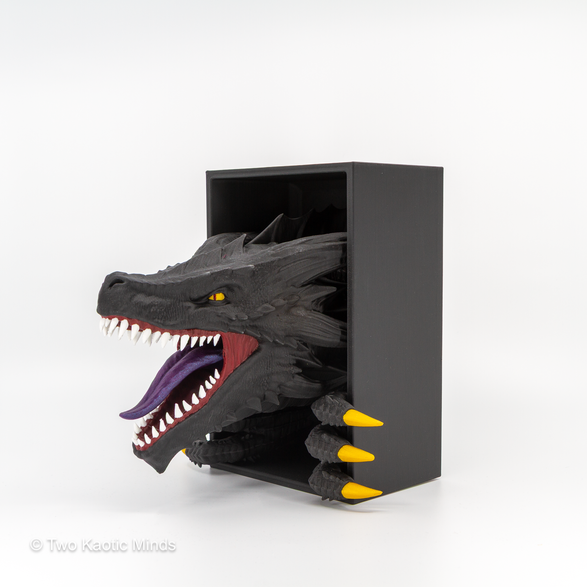 Side view of the Emerging Dragon book nook showing the dragon head profile bursting through the matte black outer box with gold claws extended