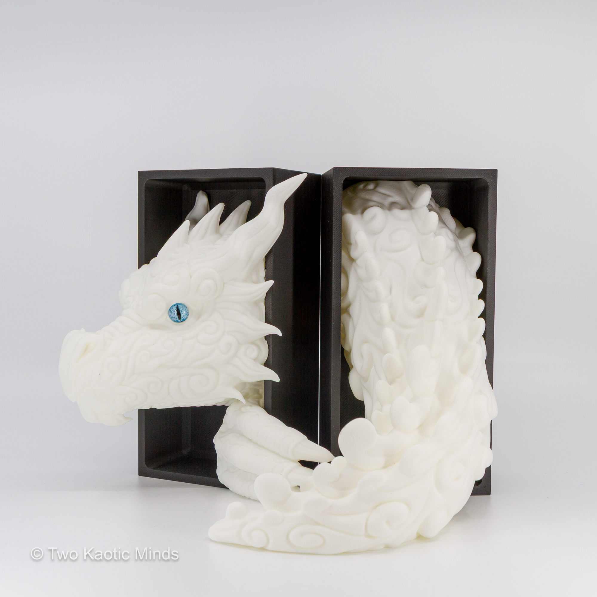 White Cloud Dragon head and tail set shown together with matte black outer box, angled view showing both sculpted pieces
