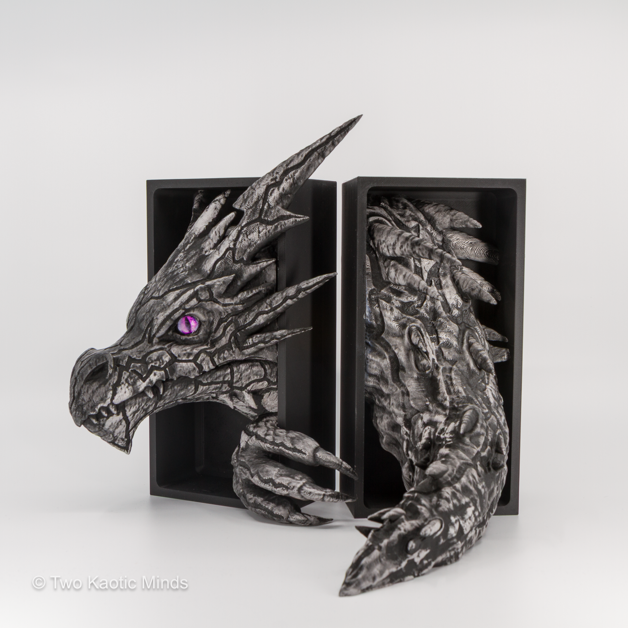 Lightning Dragon head and tail set shown together with matte black outer box, angled view showing full pewter-finished dragon detail and purple eye