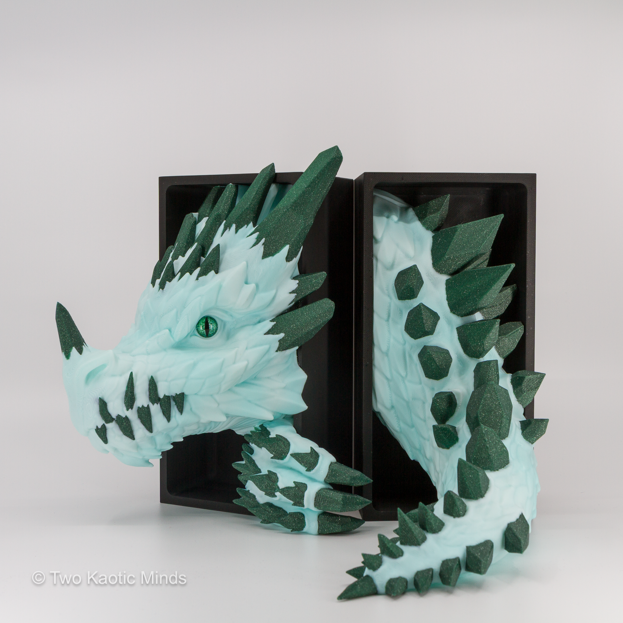 Green Crystal Dragon head and tail set shown together with matte black outer box, angled view showing the full frost and green sparkle two-tone detail