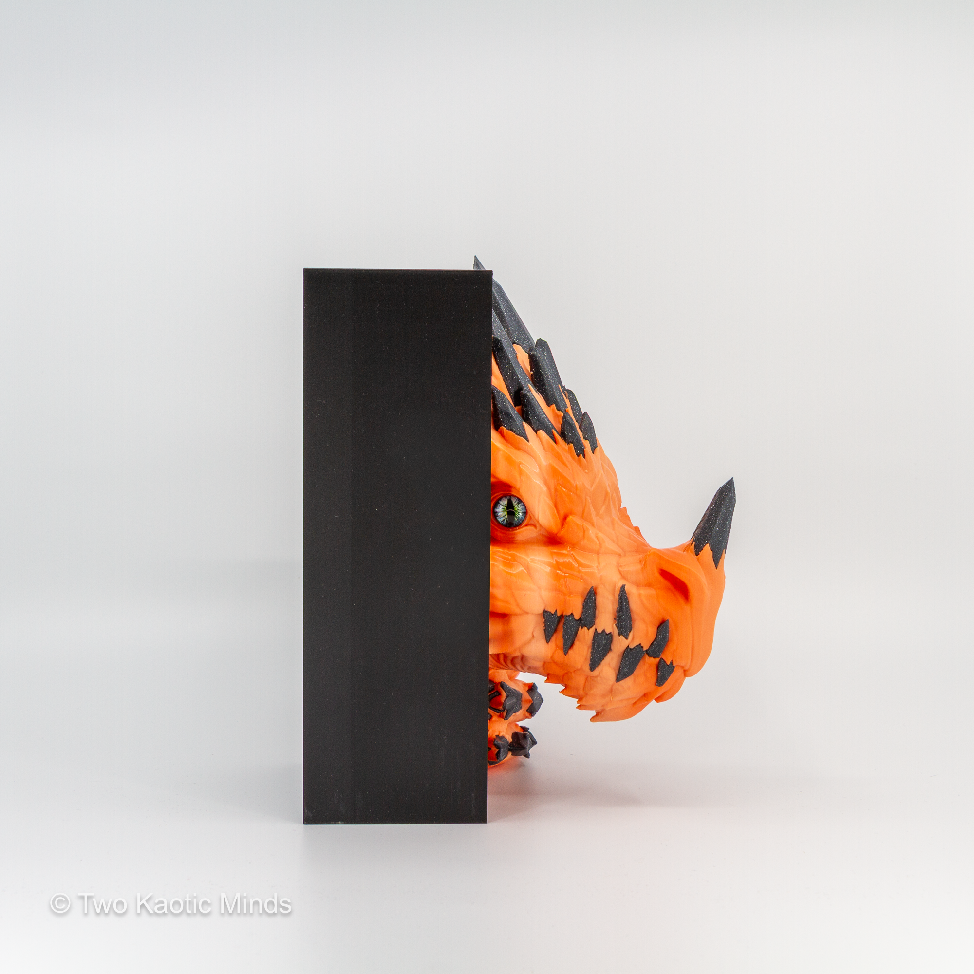 Side view of the orange Crystal Dragon book nook showing the dragon head profile against the matte black outer box