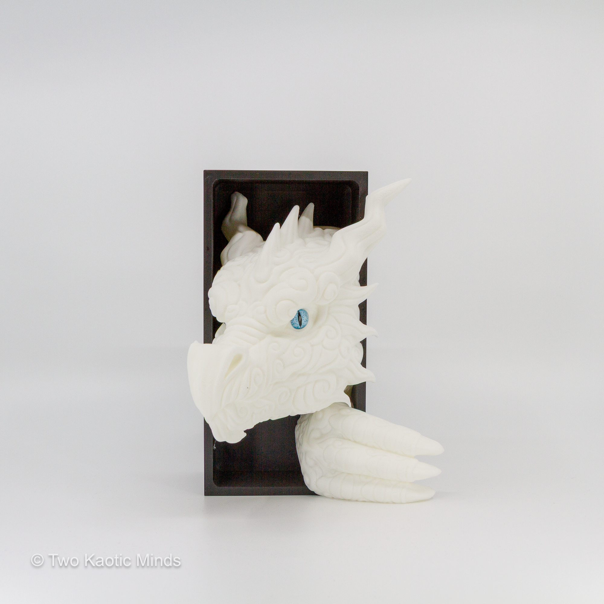 Side view of the white Cloud Dragon book nook showing the dragon head profile against the matte black outer box