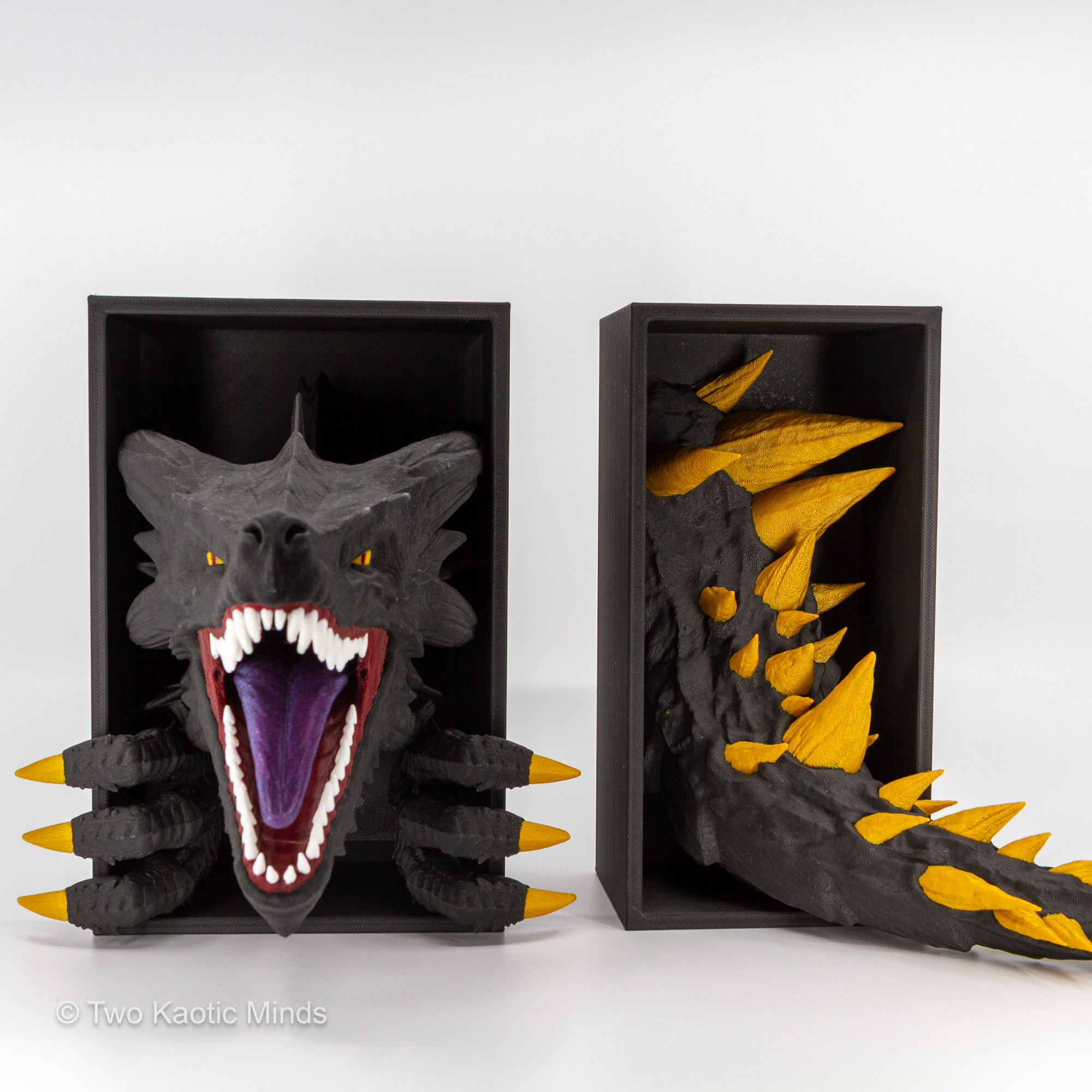 Emerging Dragon head and tail set shown together at an angle showing both pieces with gold spine and claw accents against matte black boxes
