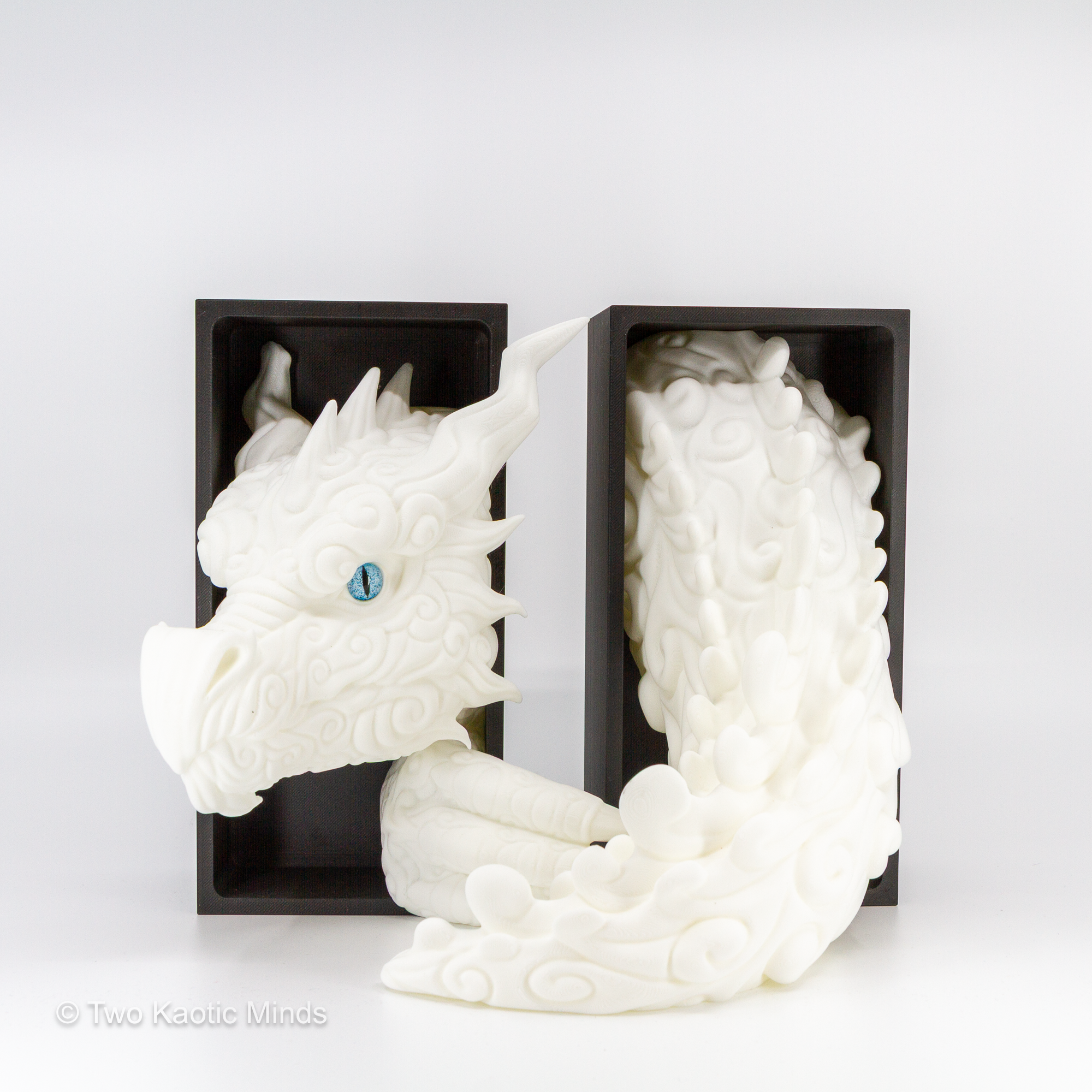 Close front angle of the white Cloud Dragon showing bright white scale texture, blue eyes, and cloud-like sculpted detail