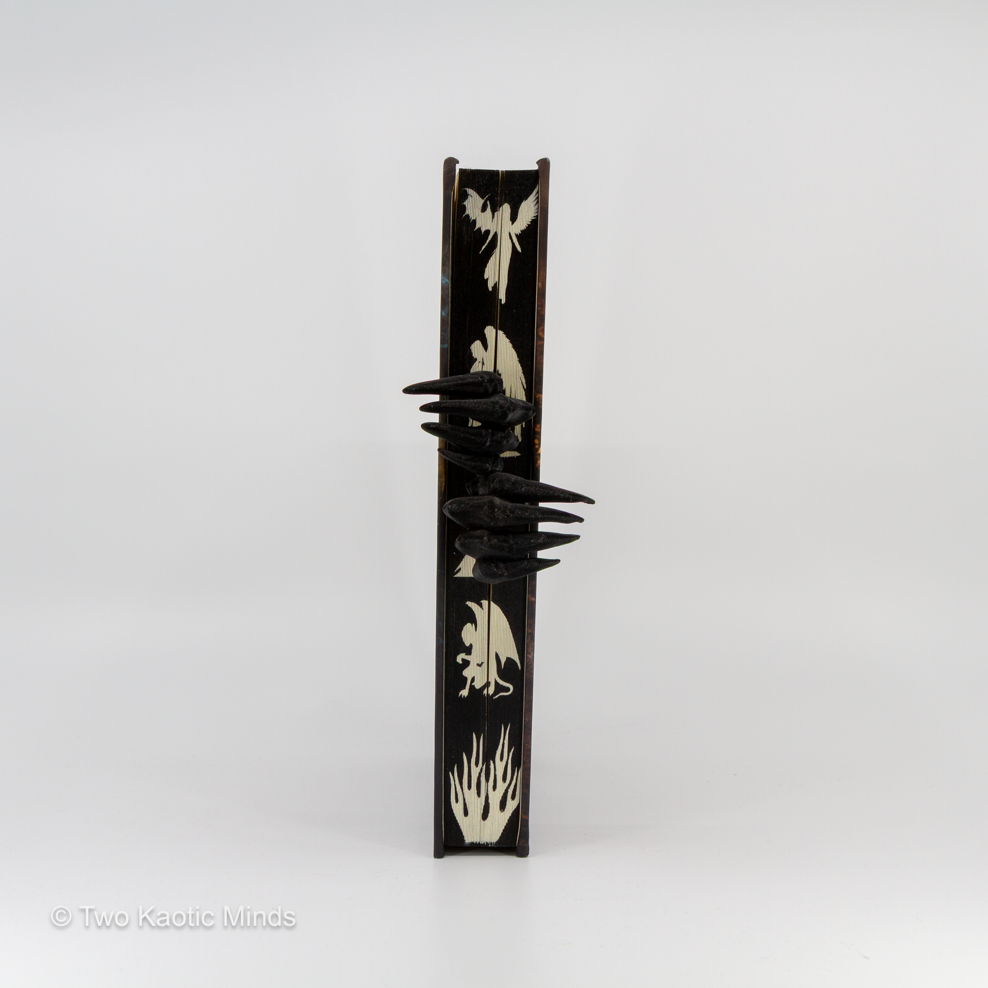 3D printed matte black Demon Hands bookmark standing upright on grey background, front view showing skeletal demon claw hands