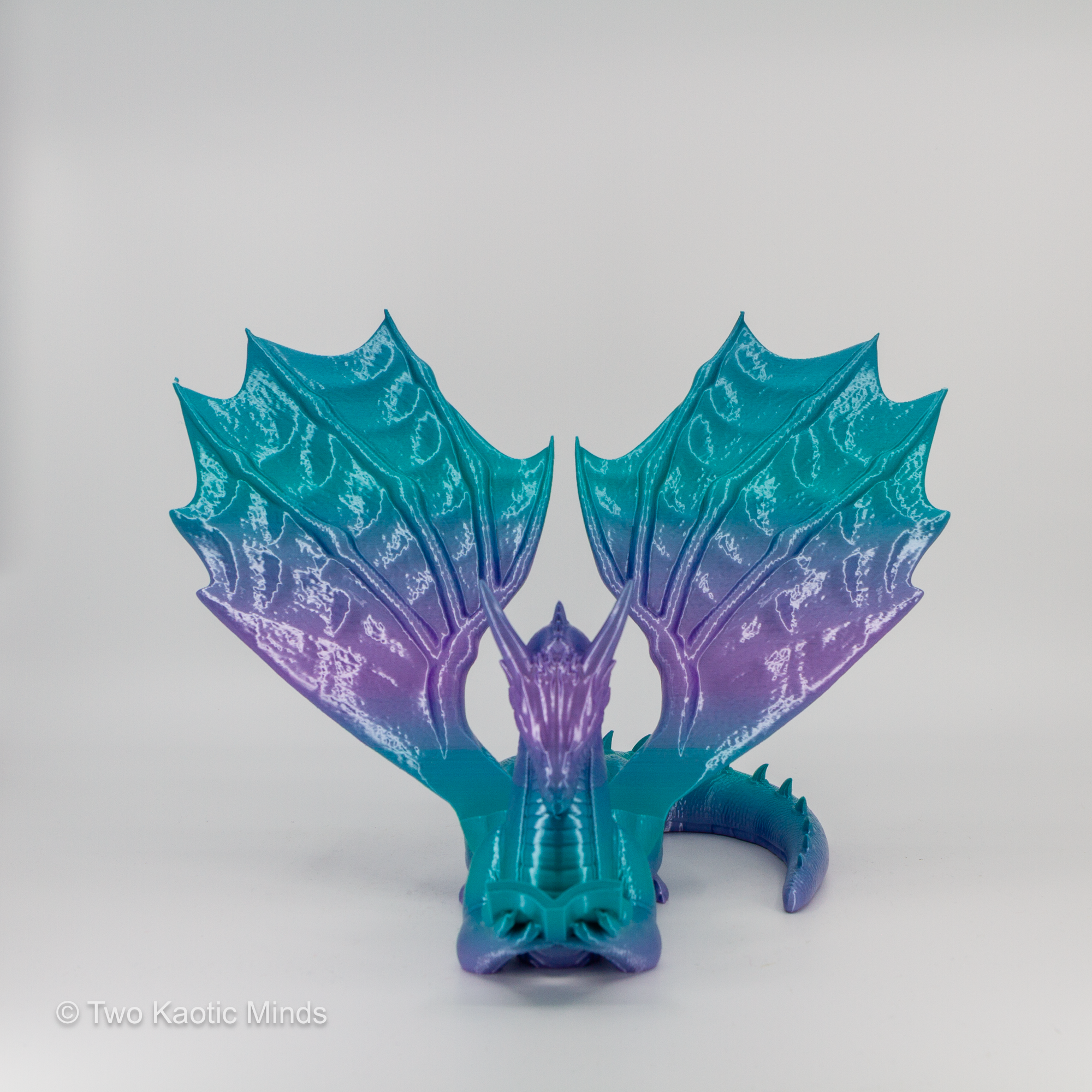 Mermaid gradient dragon book holder angled right view showing teal to purple color transition across wings