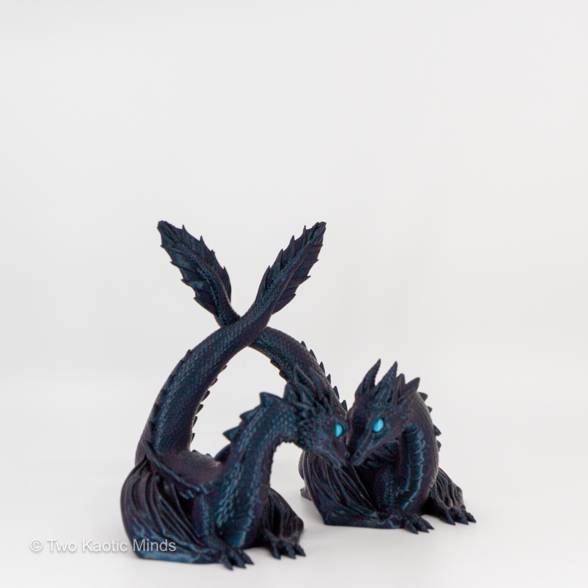 3D printed Burnt Titanium dark teal and black twin dragon book holder, two dragons facing each other, front view