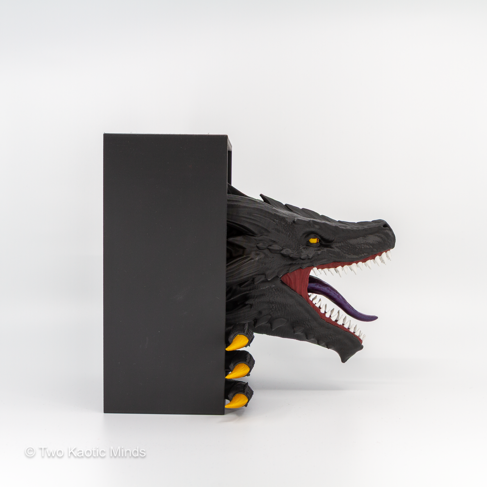 Rear angle view of the Emerging Dragon book nook showing the matte black outer box and gold-tipped tail and spine detail