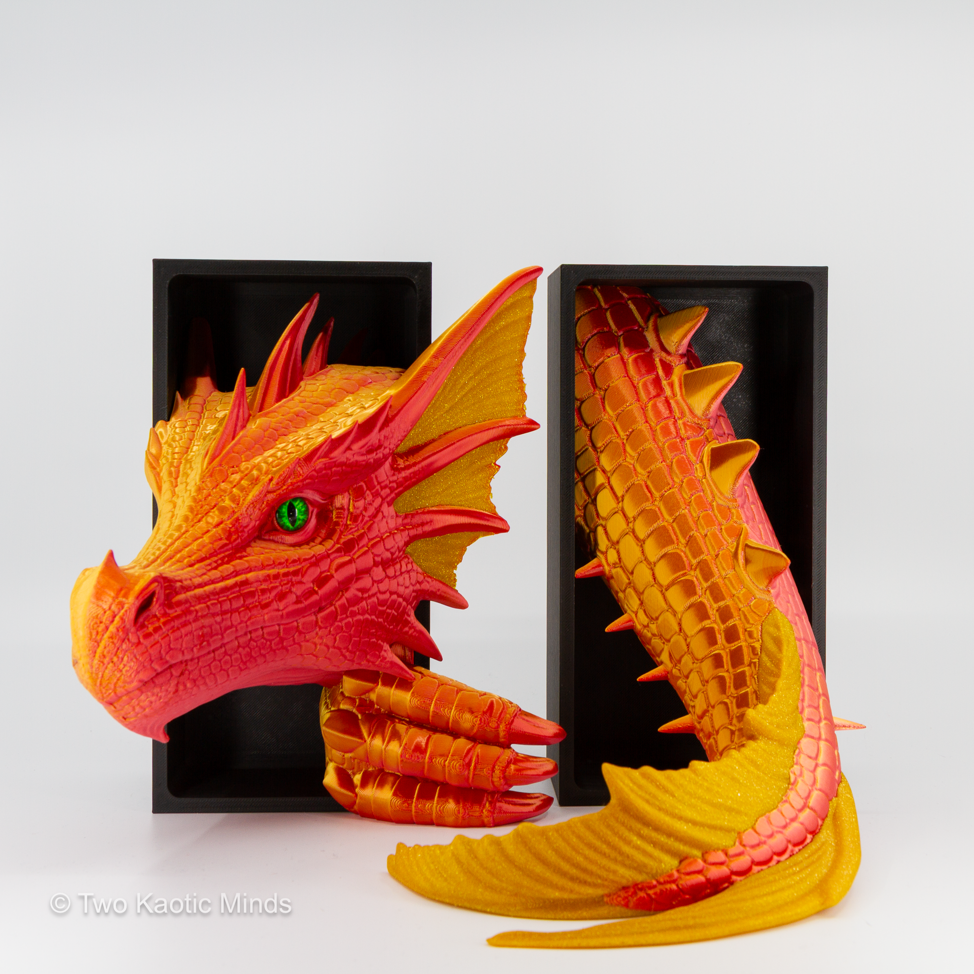 Sunset-Gold Sea Dragon book nook in use with a book between the head and tail, showing bold red-orange body and warm gold accent fins