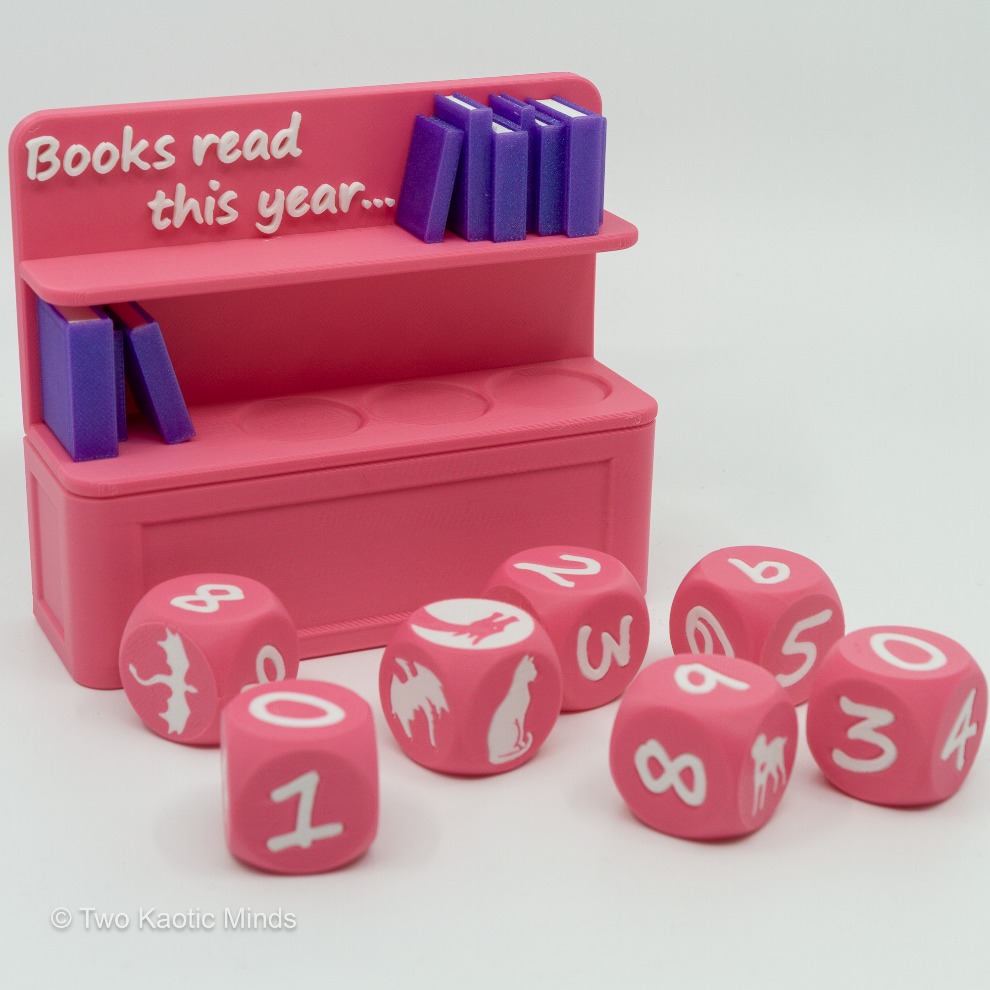 Pink Book Counter with six dice arranged loosely in front, showing icon and number variety
