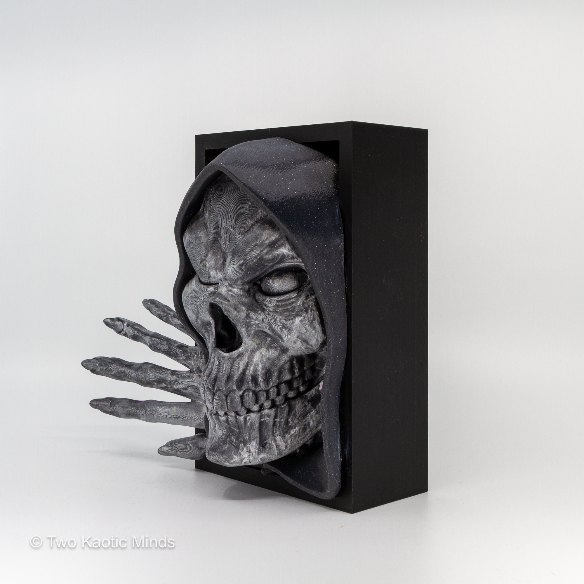 Opposite side angle of the Bone Keeper book nook showing the skeletal hand reaching out from the black box with skull face visible