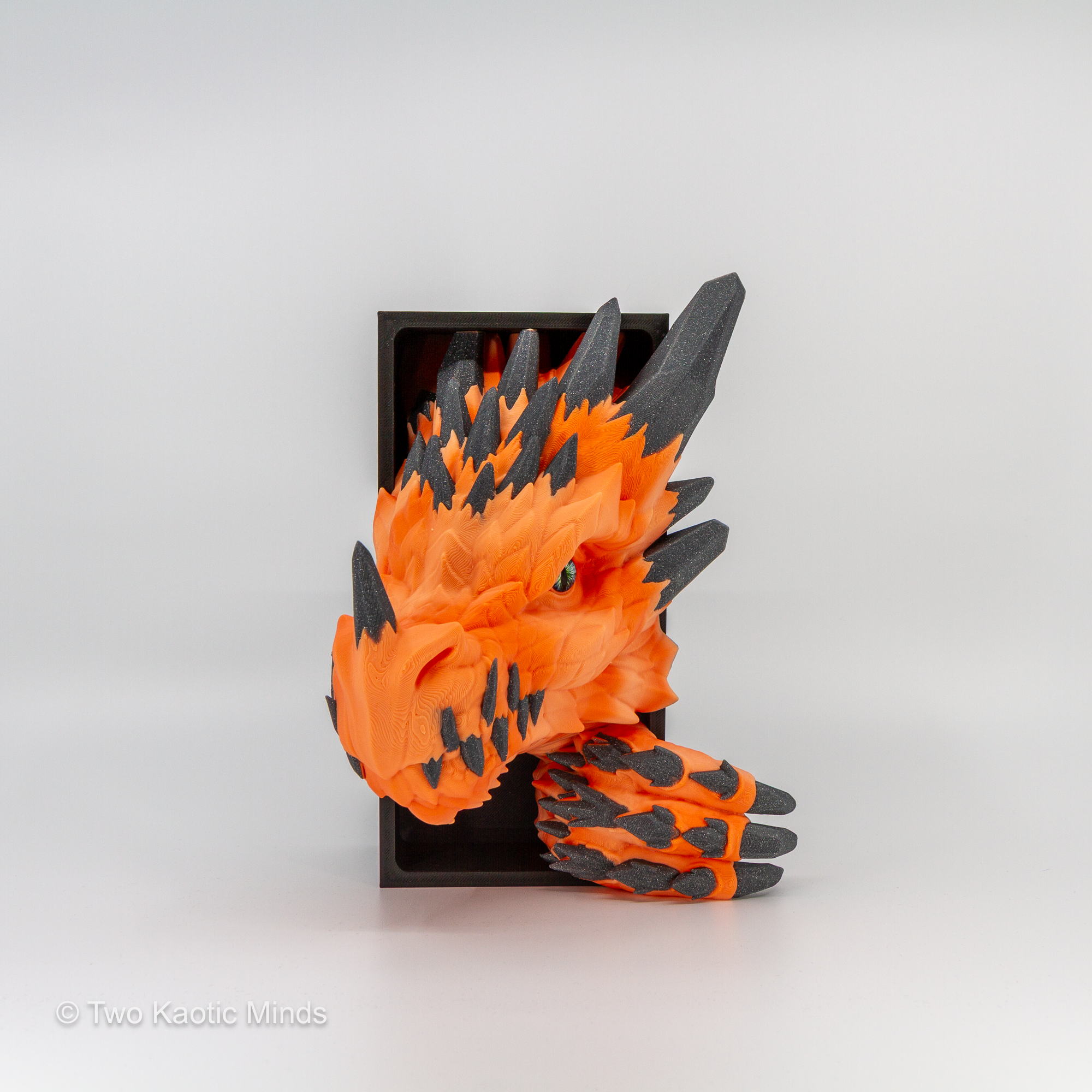 Angled front view of the orange Crystal Dragon book nook showing warm orange body and charcoal grey sparkle crystal scale detail