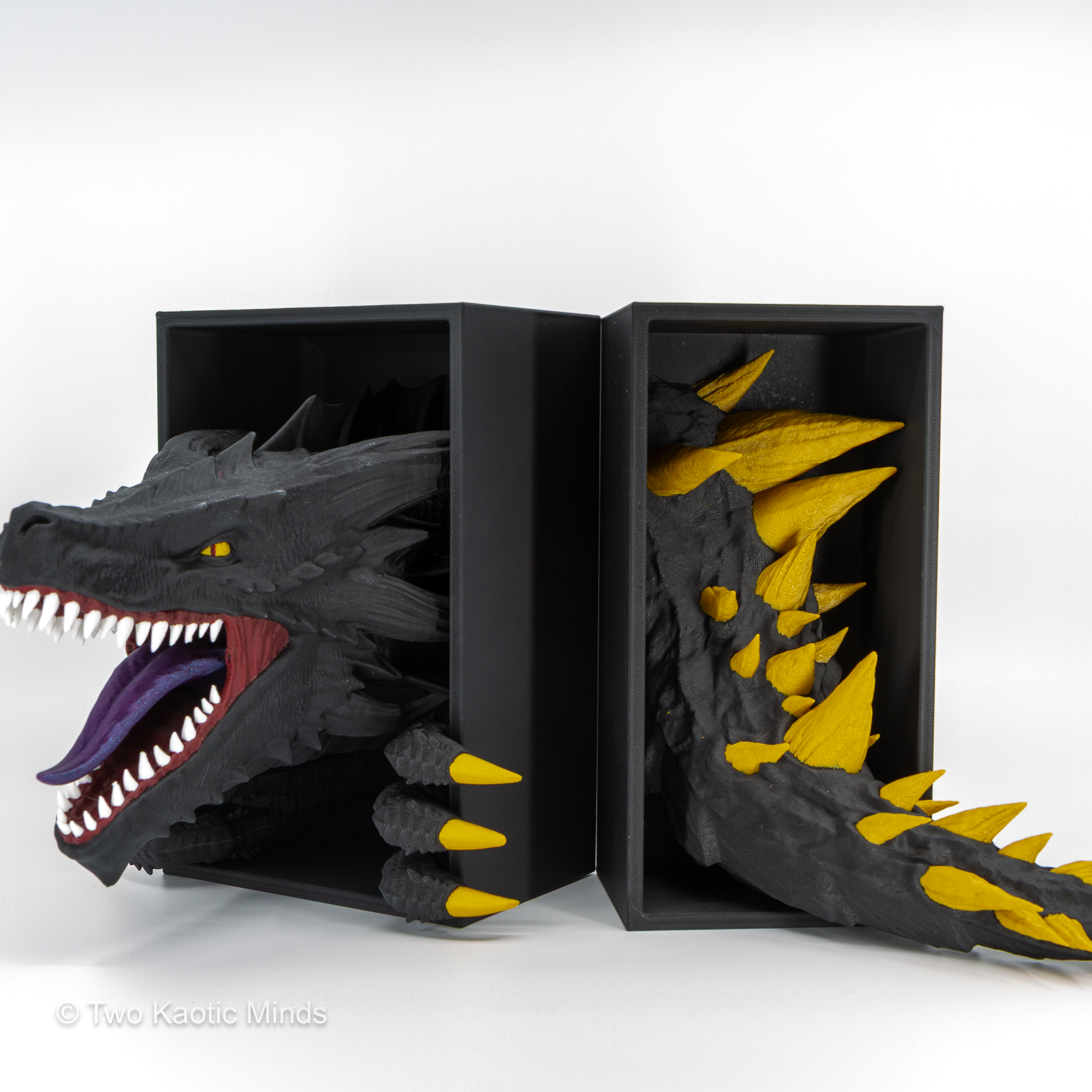Emerging Dragon head and tail set shown together side by side with matte black outer boxes, front view showing full black, gold, and purple multi-color detail
