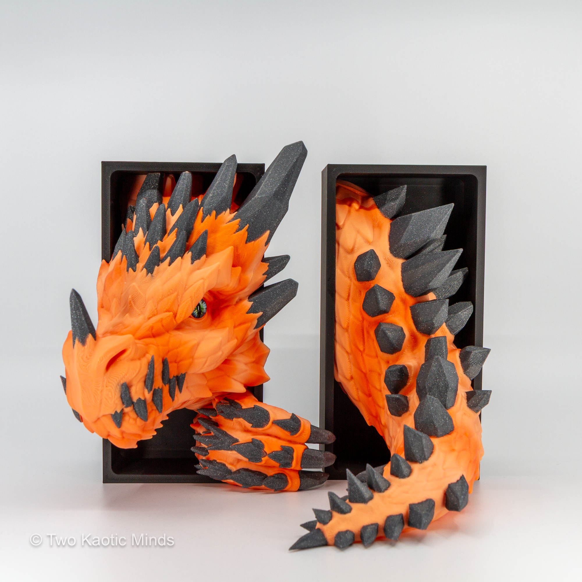 Close front angle of the orange Crystal Dragon showing warm sunrise gradient body and charcoal grey sparkle crystal scale formations