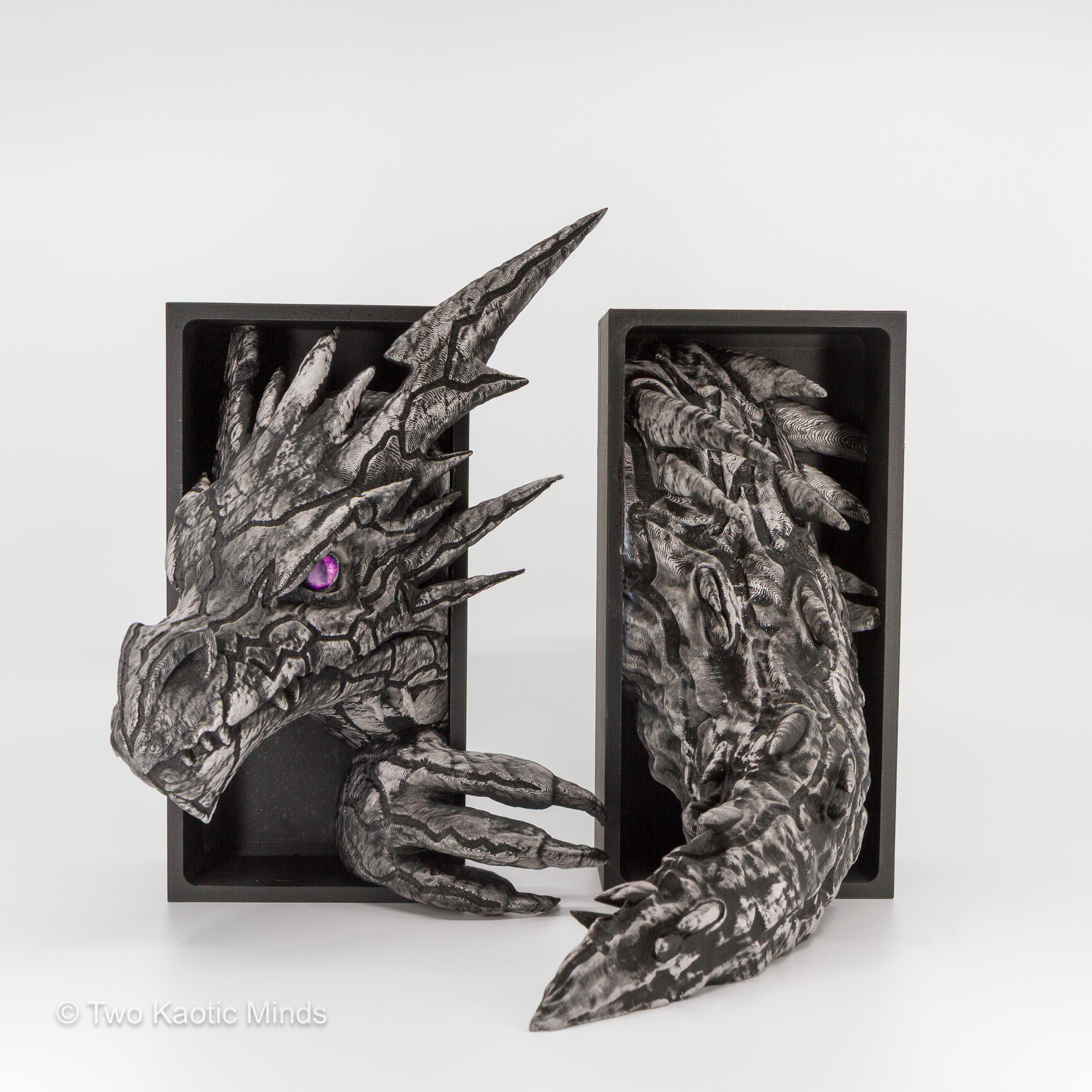 Close front angle of the Lightning Dragon showing hand-applied pewter Rub and Buff finish detail, sharp spine formations, and angular armored scale texture