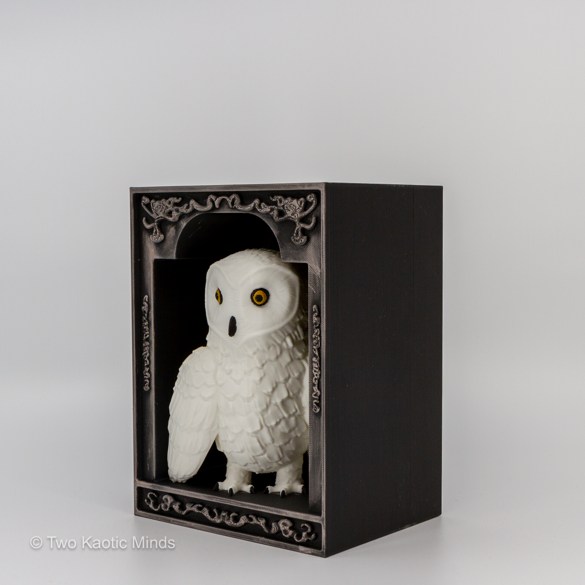 Side angle view of the owl book nook showing depth of the ornate matte black box and white owl perched inside