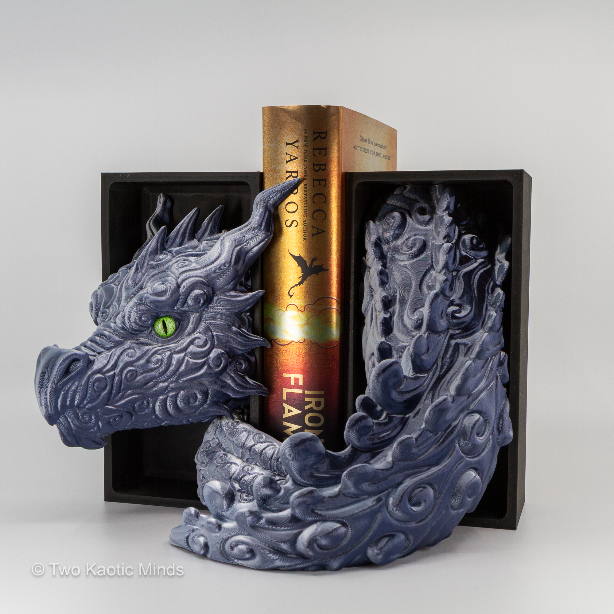 Granite Cloud Dragon book nook in use between two books on a shelf showing the dragon head and tail set framing the books