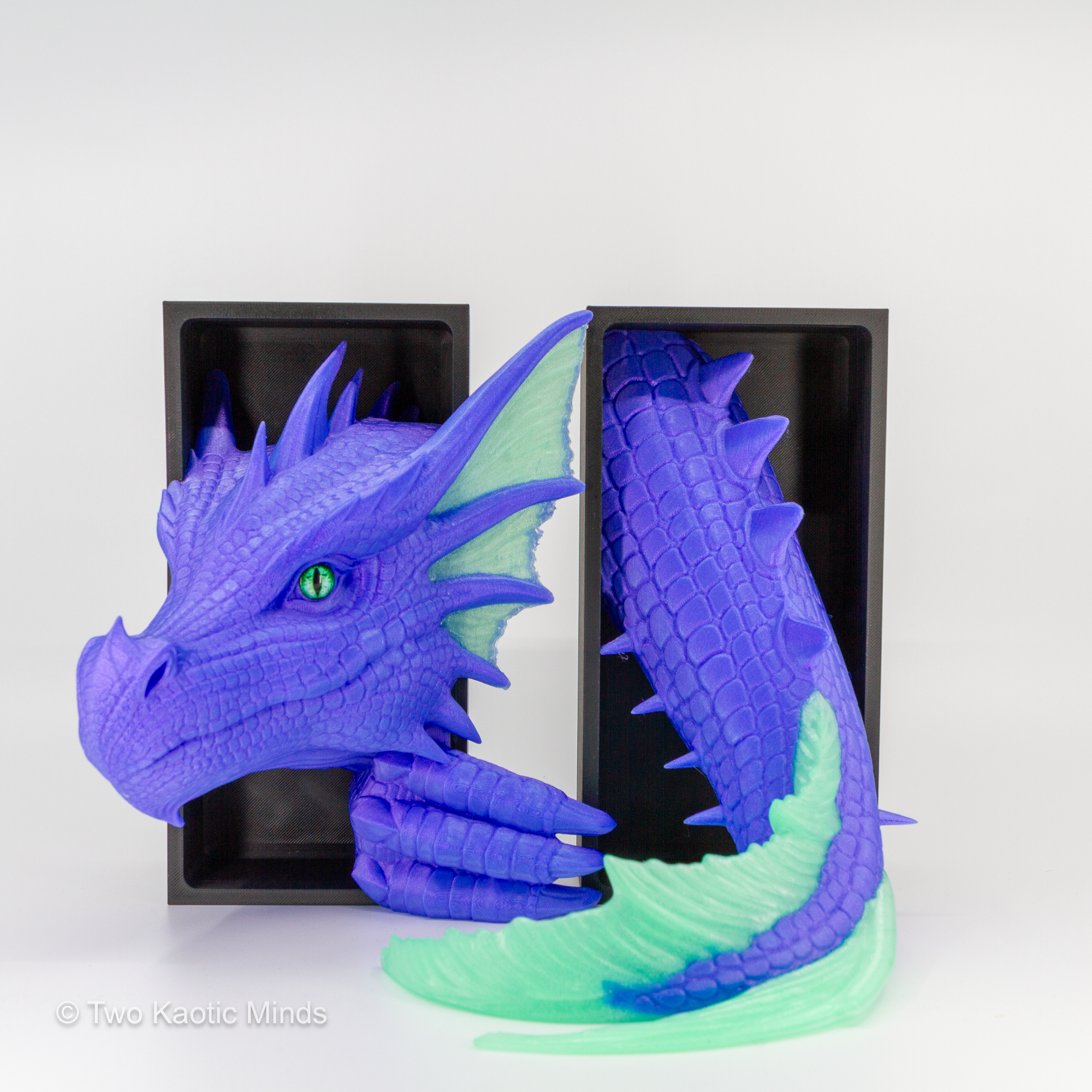 Pulsar-Jade Sea Dragon book nook in use with a book between the head and tail, showing vibrant purple body and glowing jade green accent fins