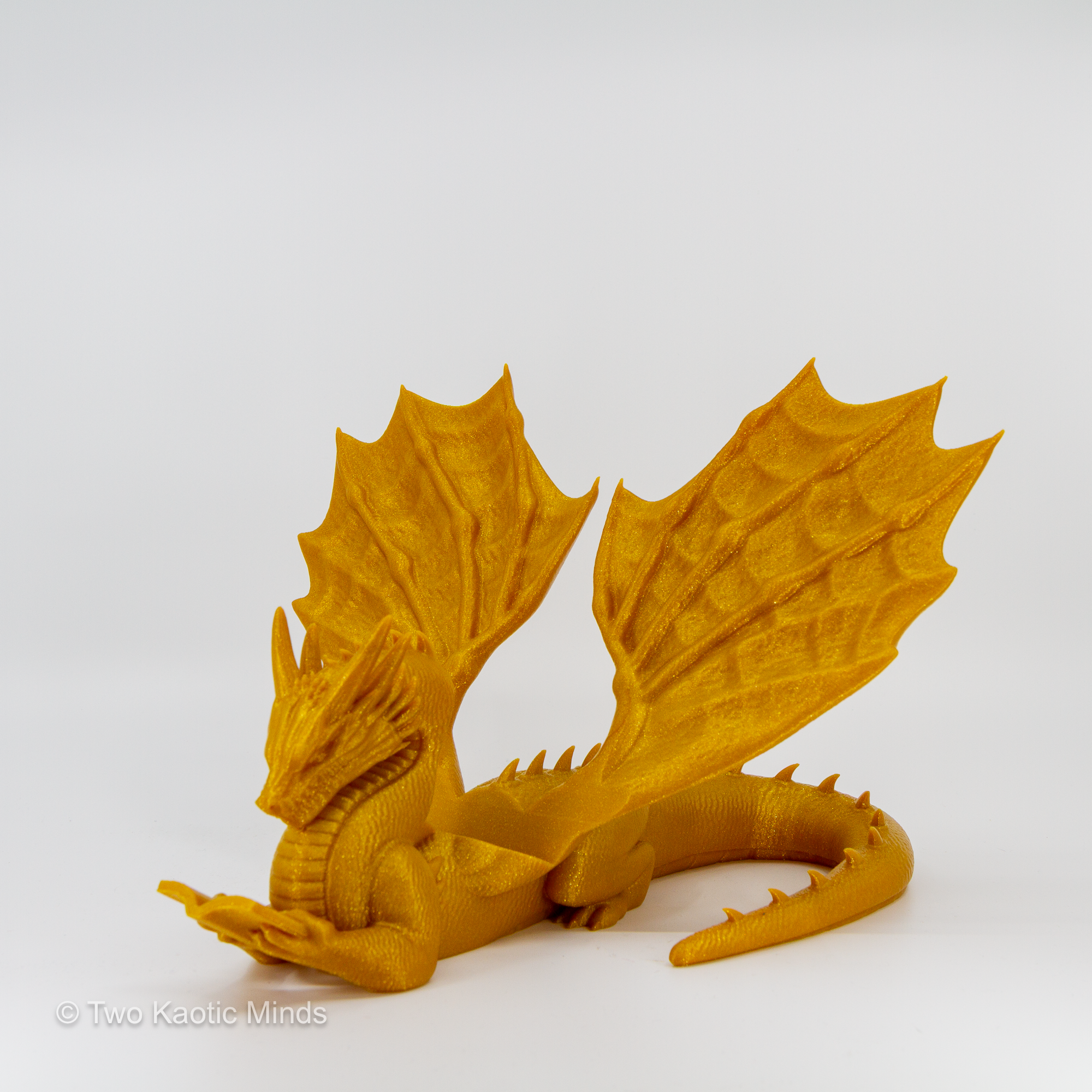 Rear angle view of gold 3D printed dragon book holder