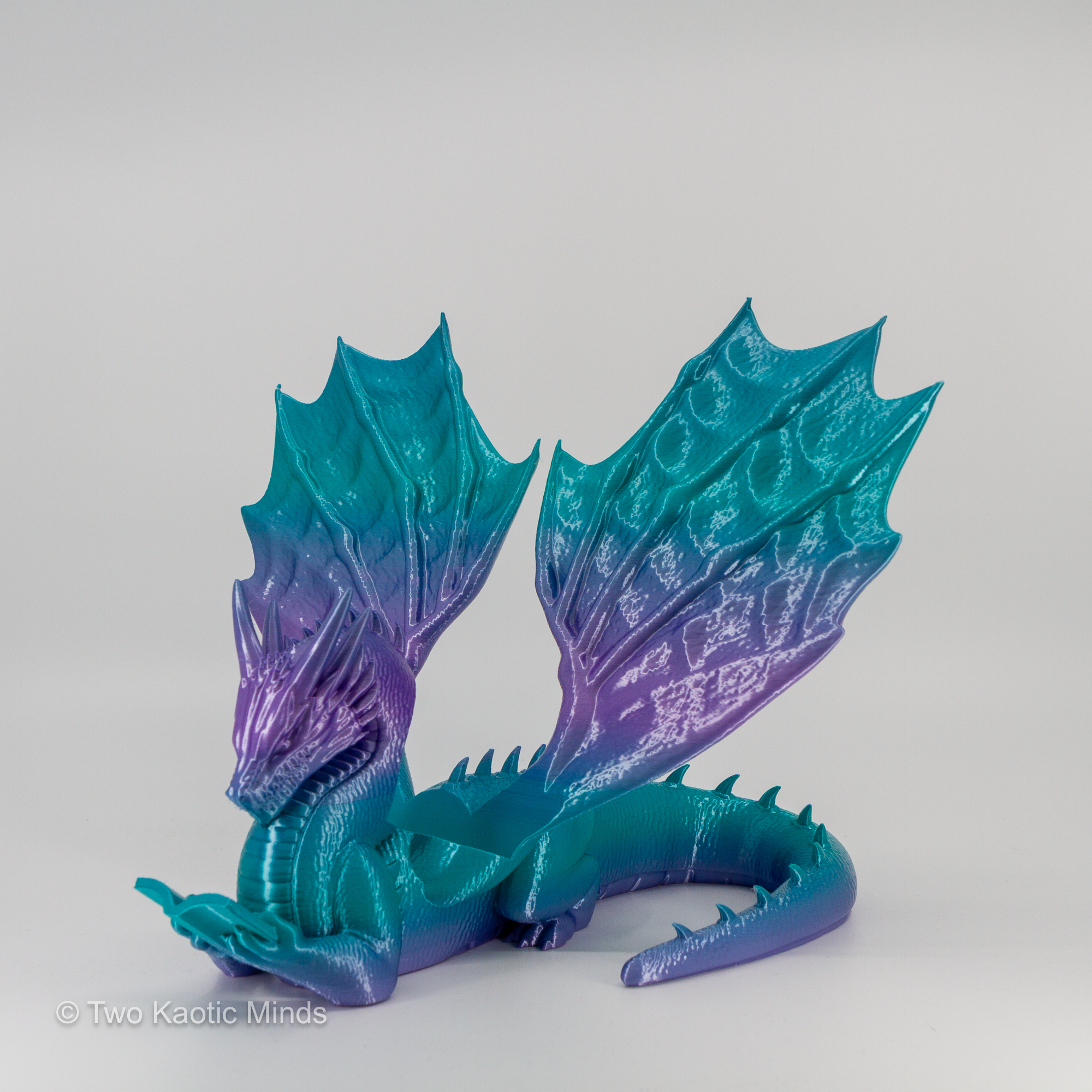 Rear angle view of mermaid gradient dragon book holder showing full teal to purple gradient across wing span