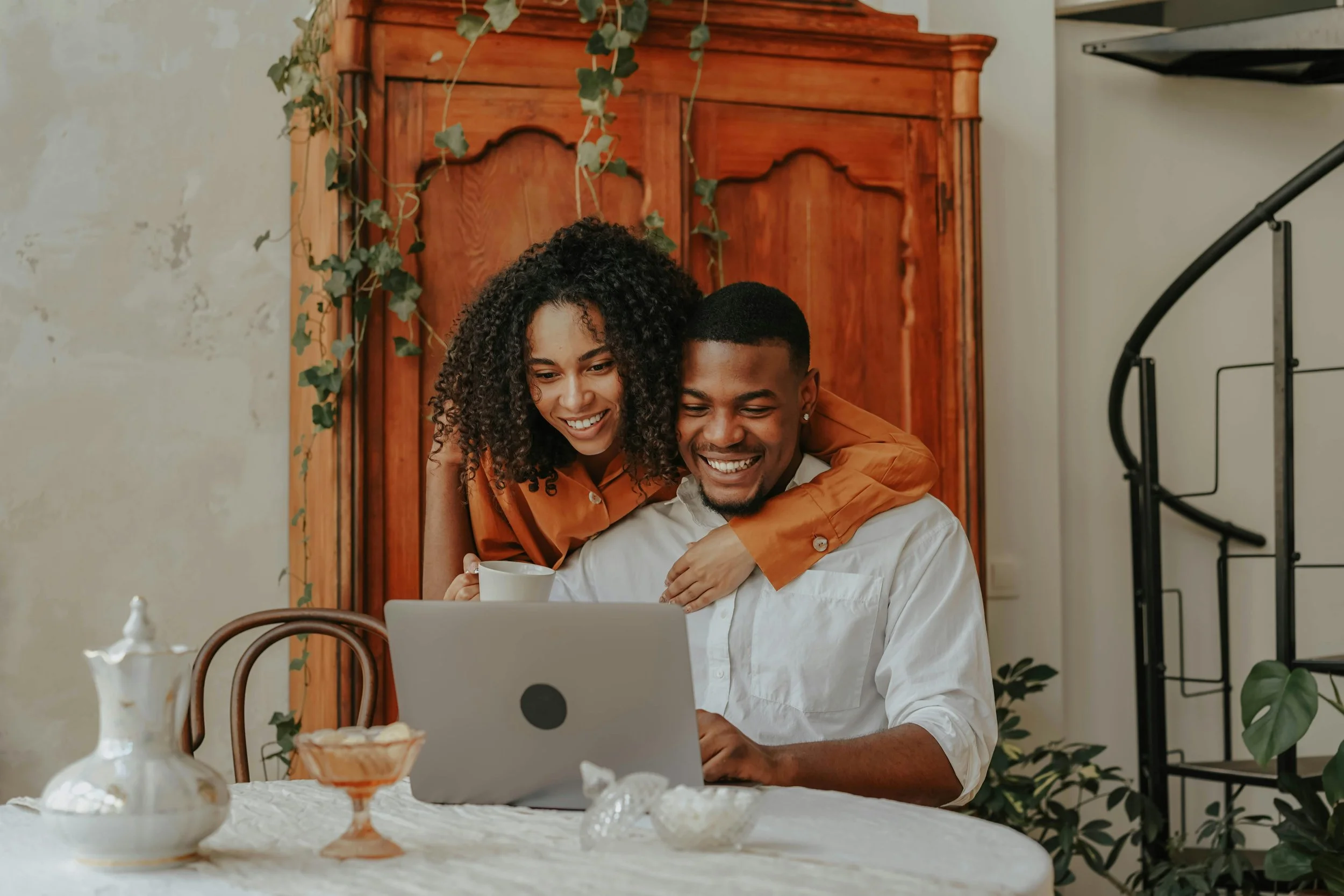 A smiling couple together at home, representing the couples communication therapy work offered virtually throughout Florida by Kristin Crumbley