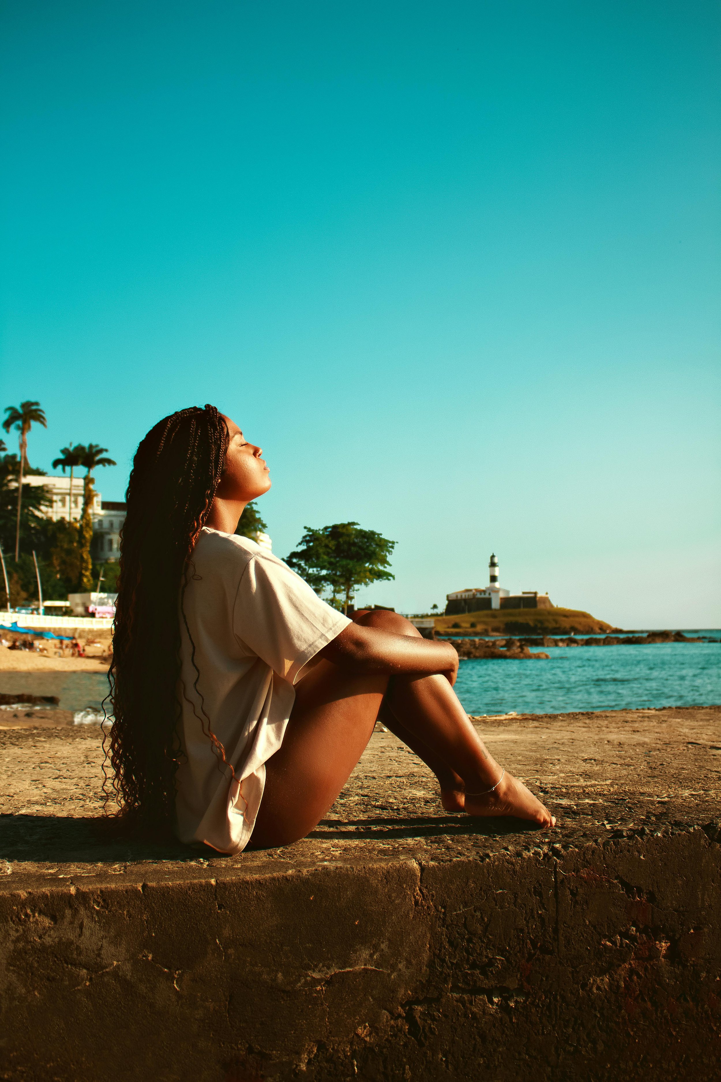 A woman relaxing peacefully near the water, representing the groundedness and clarity that communication therapy in Florida helps clients develop