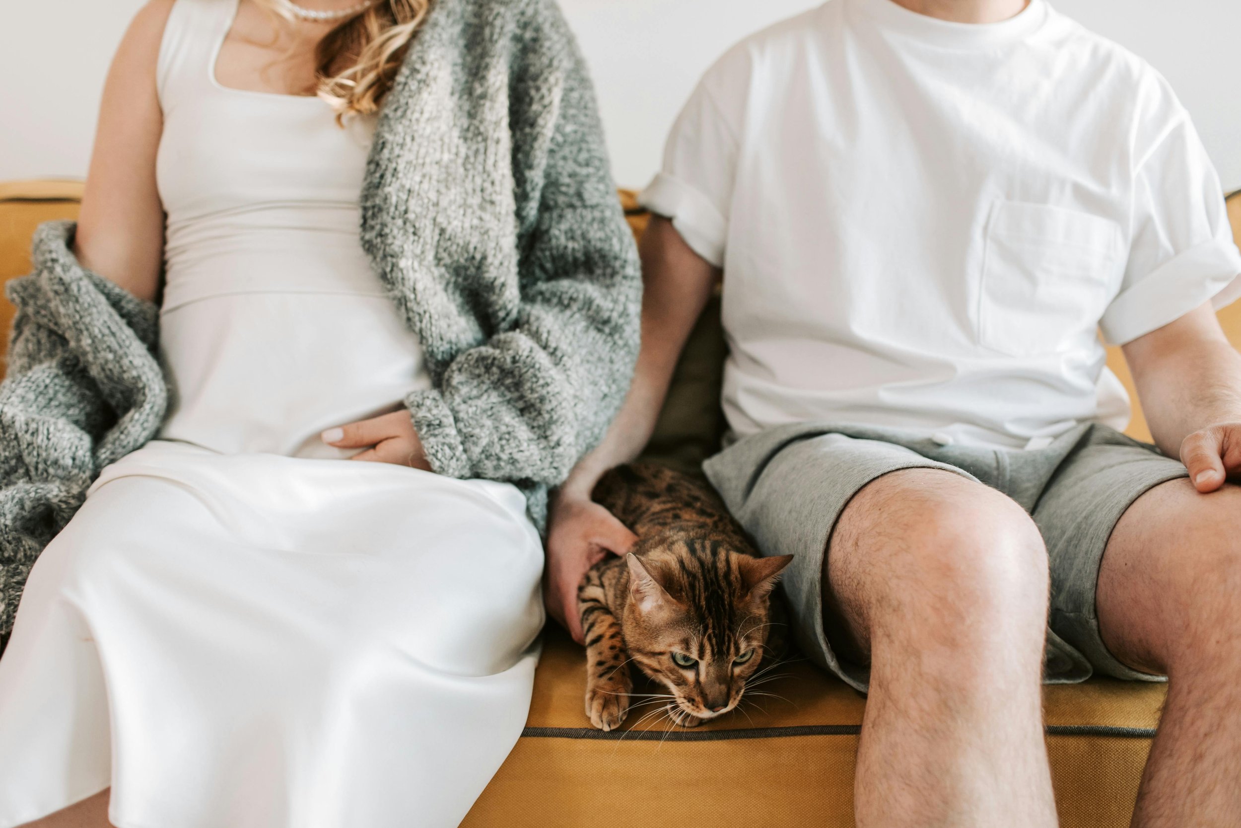 A couple sitting together with quiet emotional distance, representing the relational patterns that relationship anxiety therapy in Florida helps address
