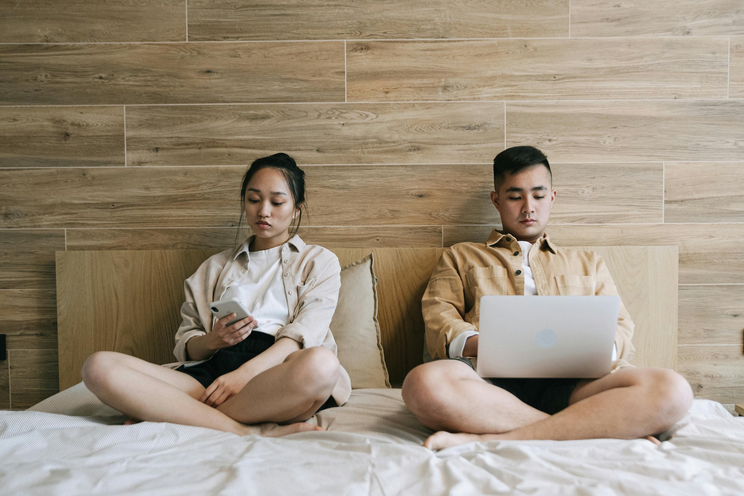 A couple sitting together in quiet distance, representing the relational impact of emotional dysregulation addressed in couples therapy in Florida