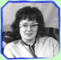 Black and white photo of a woman with glasses and curly hair, wearing a light-colored top.