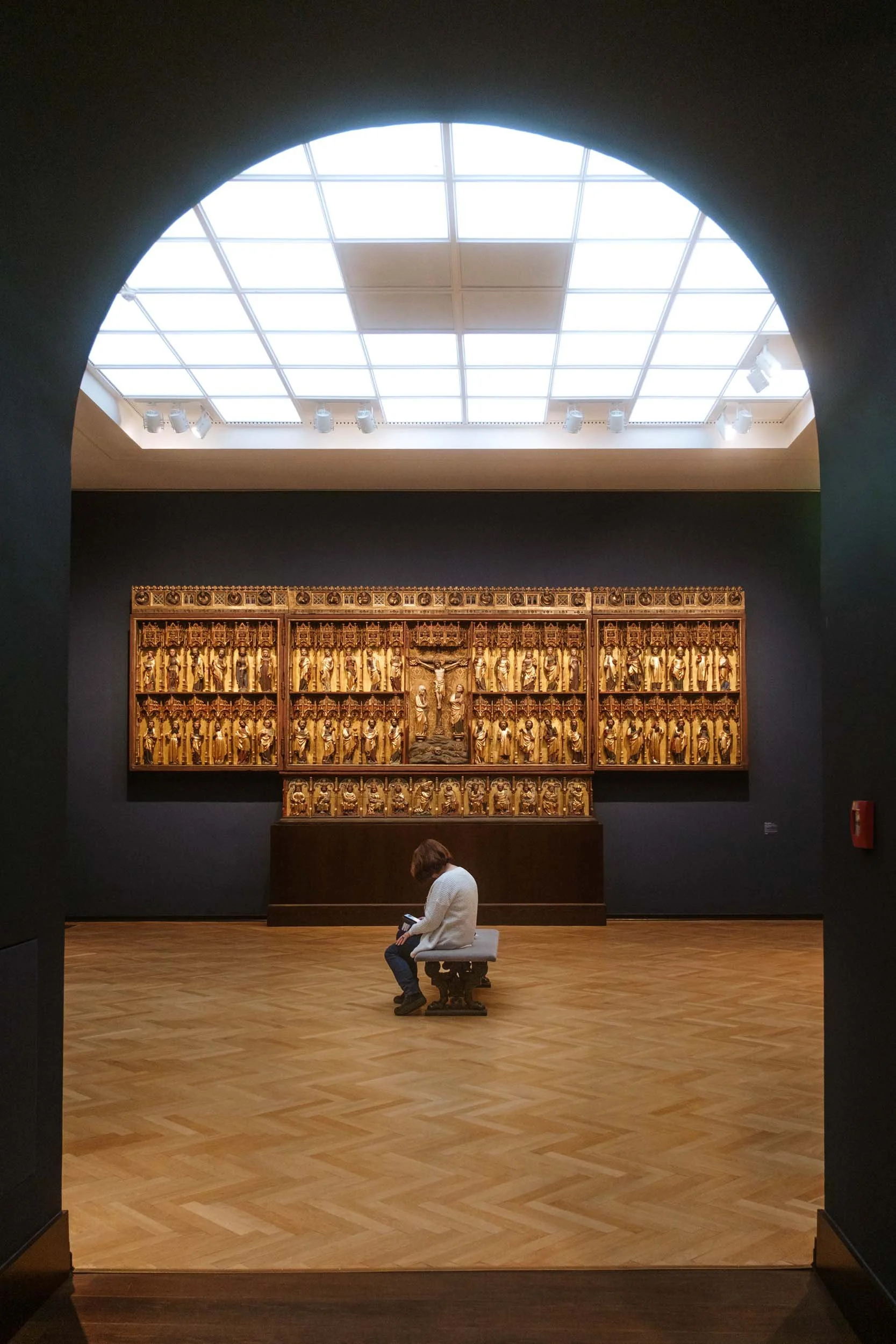 Woman sitting next to old art in Hamburger Kunsthalle