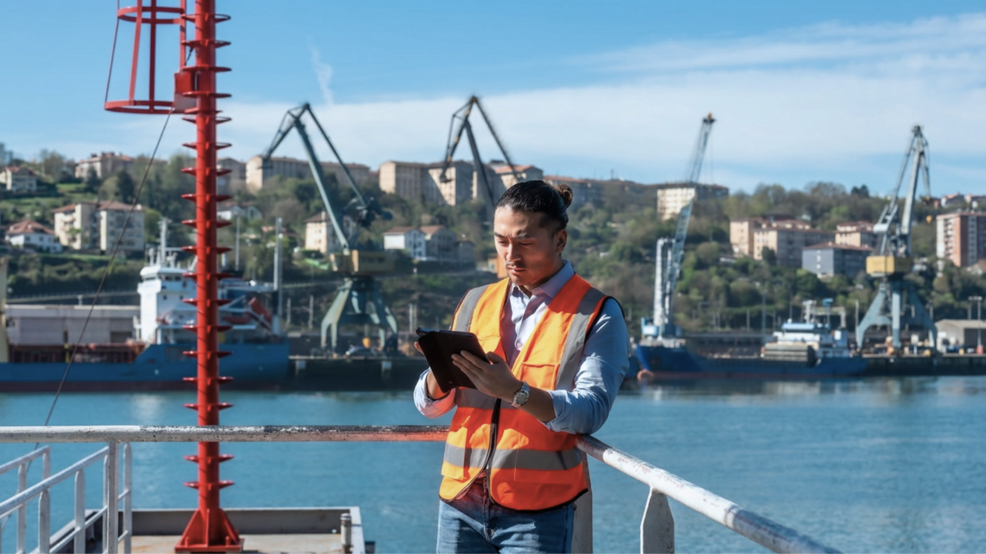 Customs agent reviewing shipment details on a tablet at a UK port.