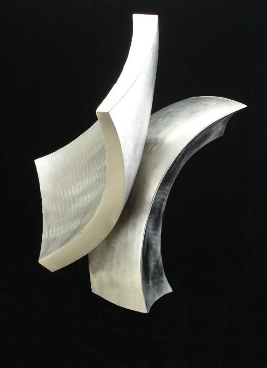 A Modern abstract sculpture with two compound curved stainless steel elements, against a black background.