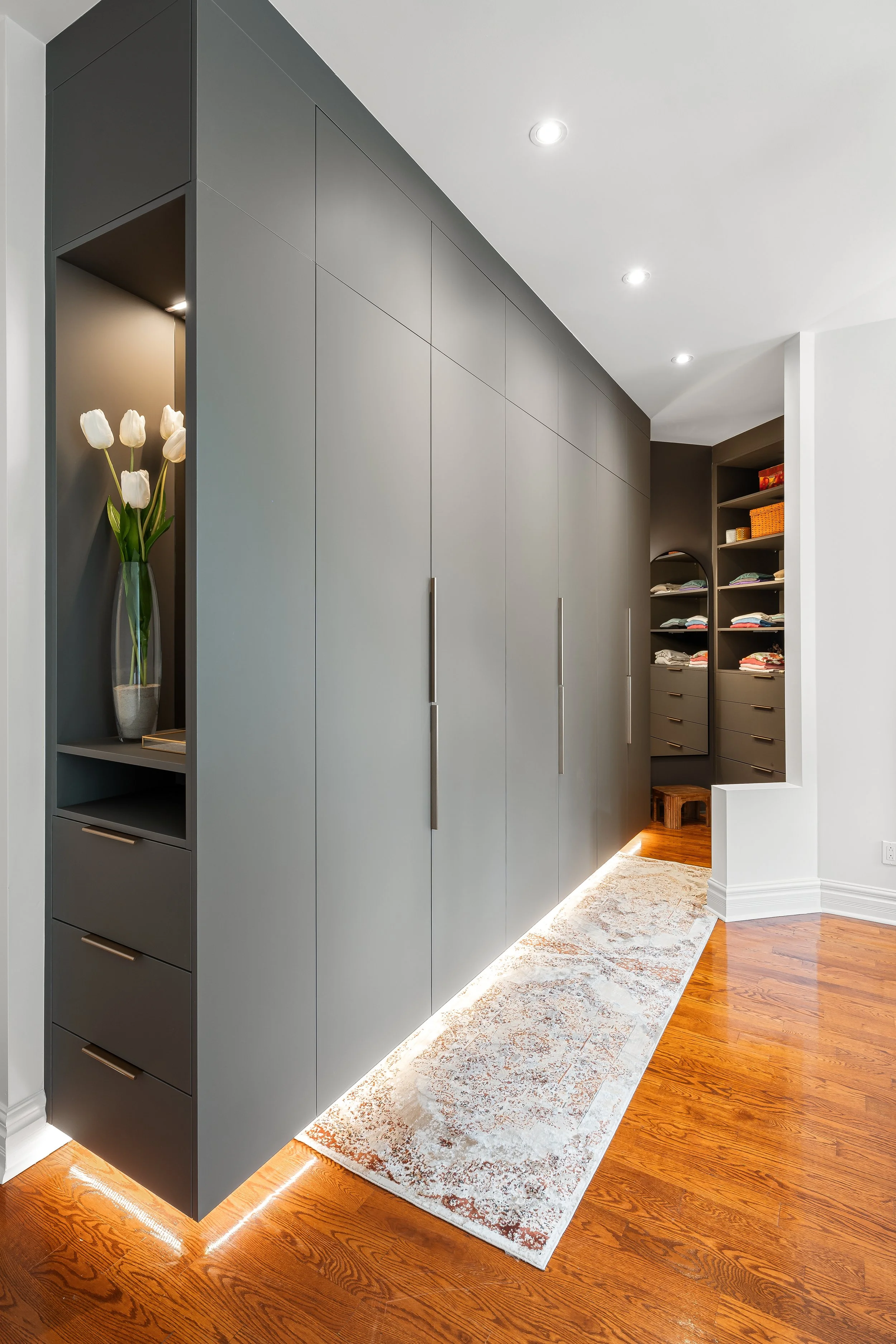 High end renovation featuring custom built-ins closets and open shelving. 