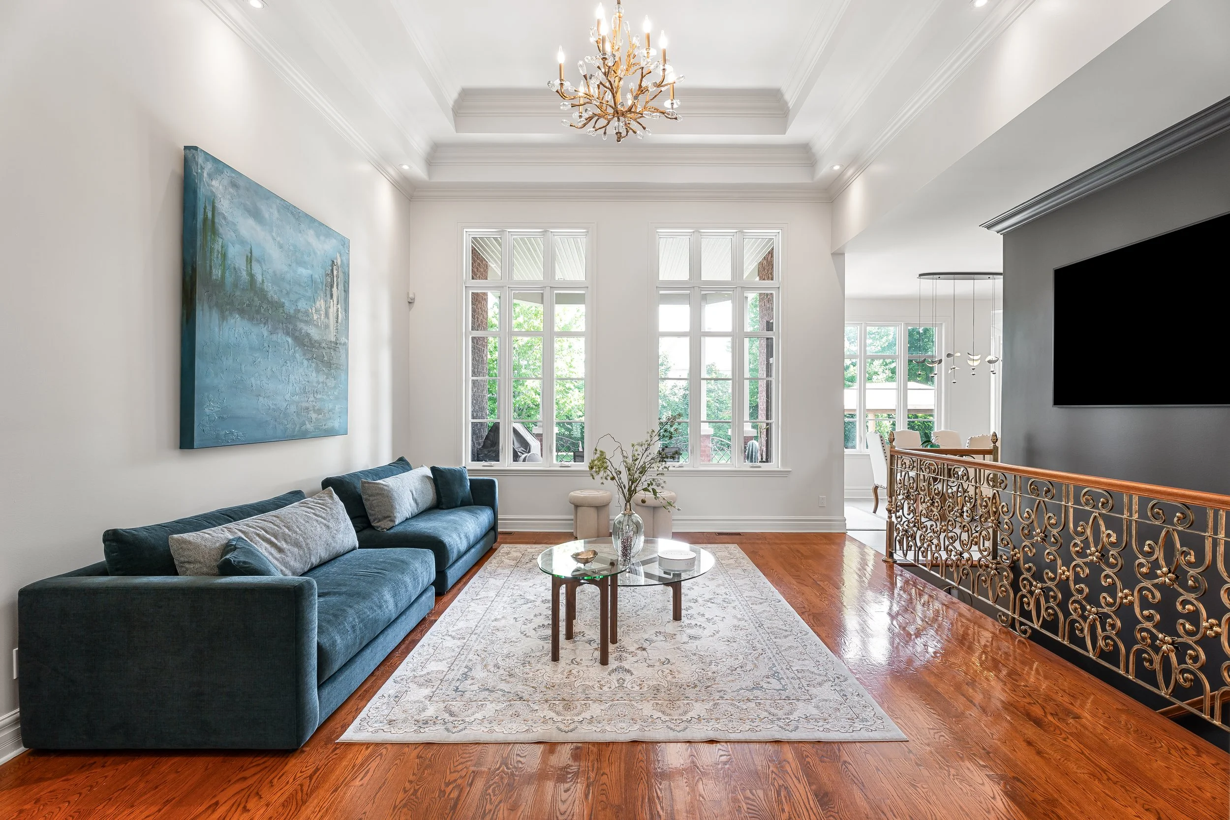 Full home renovation in Brossard near Montreal showcasing a luxurious living room with hardwood floors and custom architectural details. 