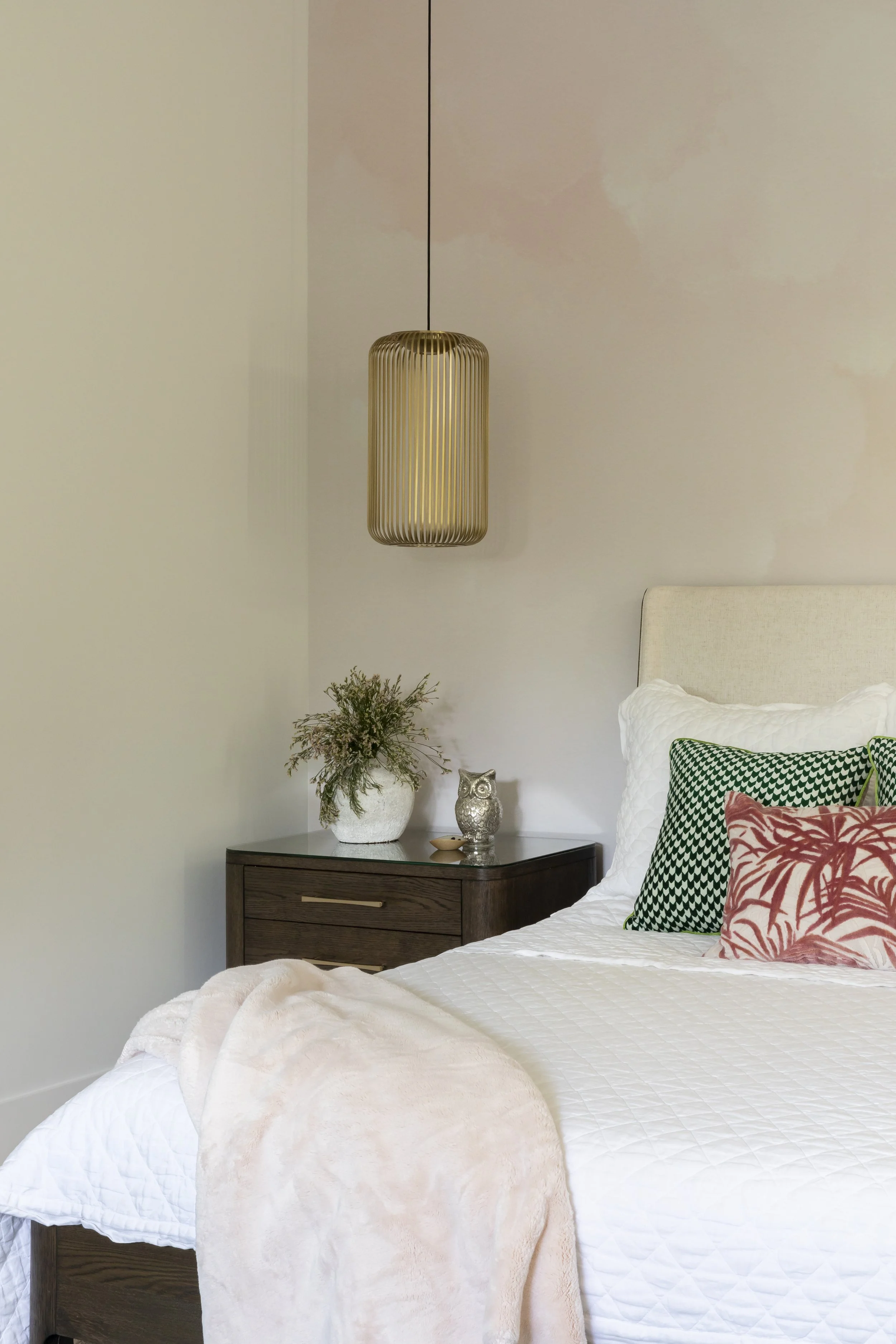Solana Beach, CA bedroom design featuring custom bedside lighting, layered textiles, and warm, modern styling for a calm and inviting retreat by Anne Flynn.