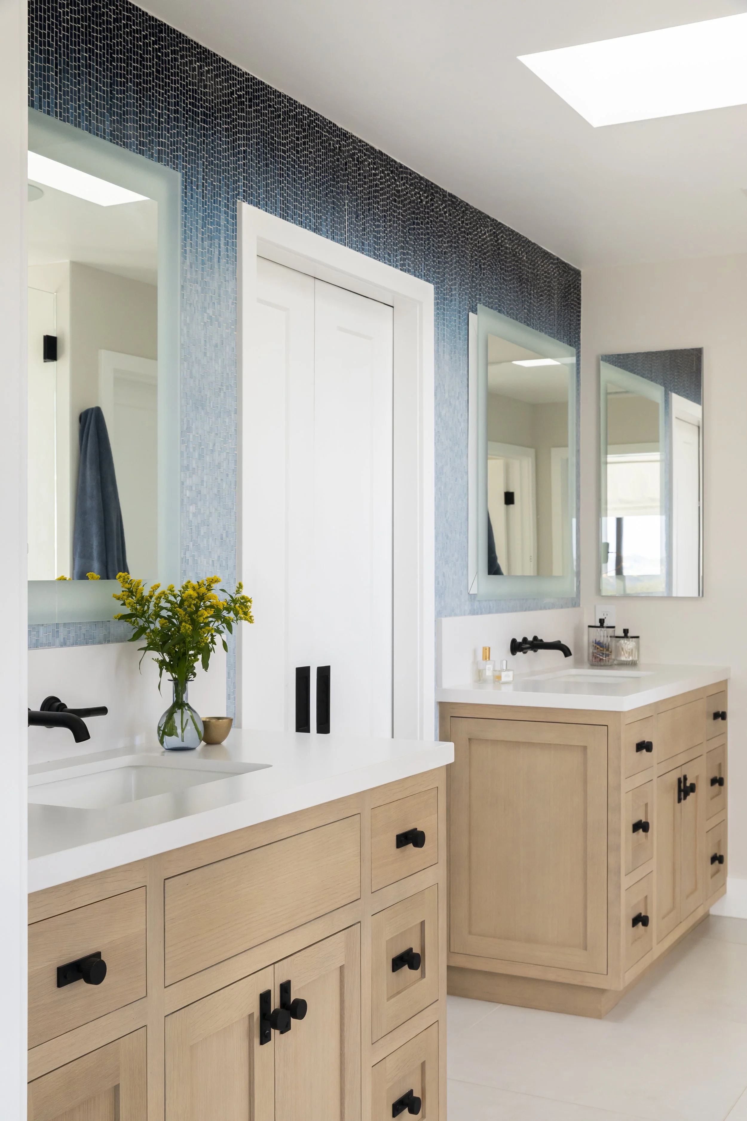 Solana Beach, CA bathroom design featuring a custom double vanity, textured blue wall tile, and clean modern finishes for a bright, functional space by Anne Flynn Designs.