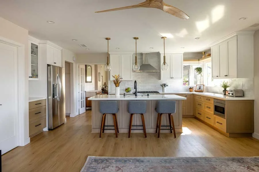 San Diego, CA kitchen design featuring a spacious central island, custom cabinetry, warm wood accents, and classic transitional finishes designed for everyday living by Anne Flynn Designs.