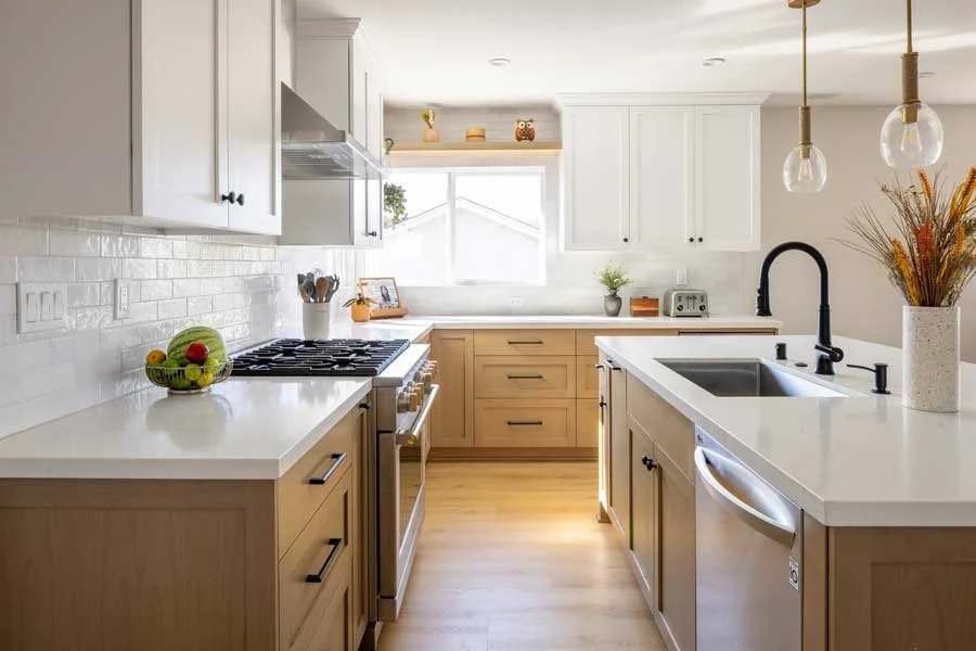 San Diego, CA kitchen design featuring custom wood cabinetry, a white quartz island, classic subway tile, and warm transitional styling by Anne Flynn Designs.
