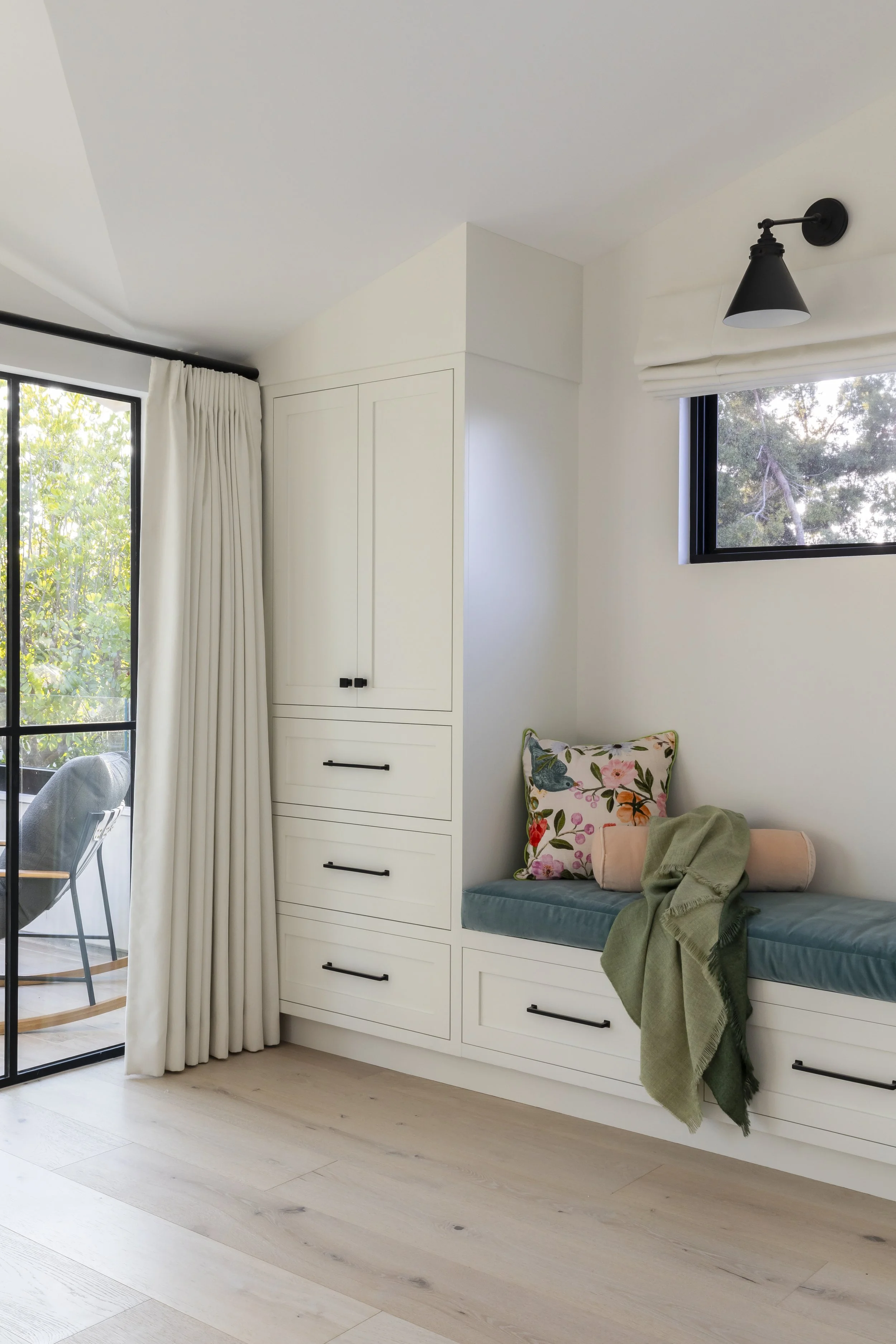 Solana Beach, CA bedroom design featuring custom built-in cabinetry, a window bench with tailored cushions, and clean modern styling by Anne Flynn Designs.