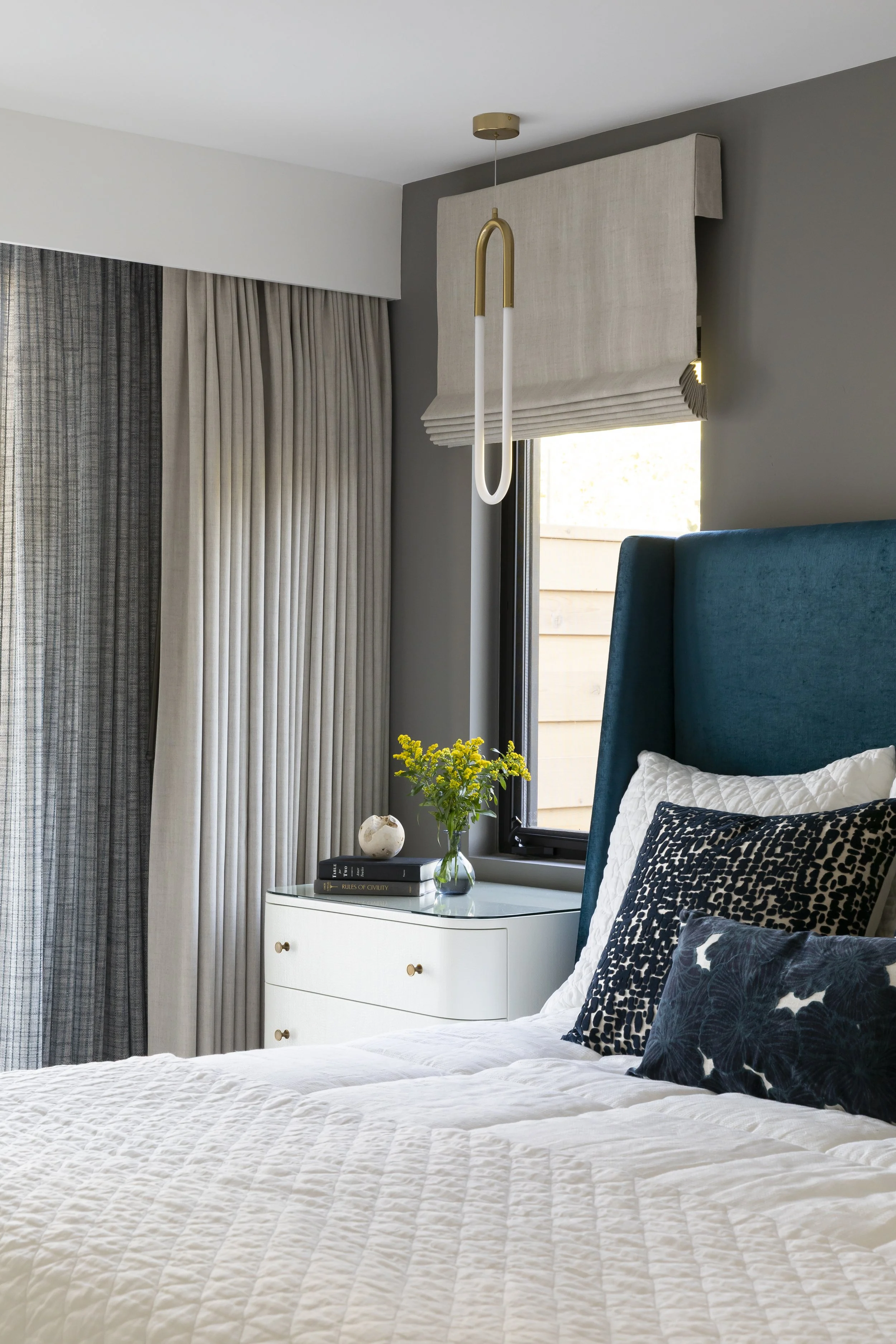 Solana Beach, CA bedroom design featuring custom window treatments, sculptural pendant lighting, and layered textiles creating a refined, modern retreat by Anne Flynn Designs.