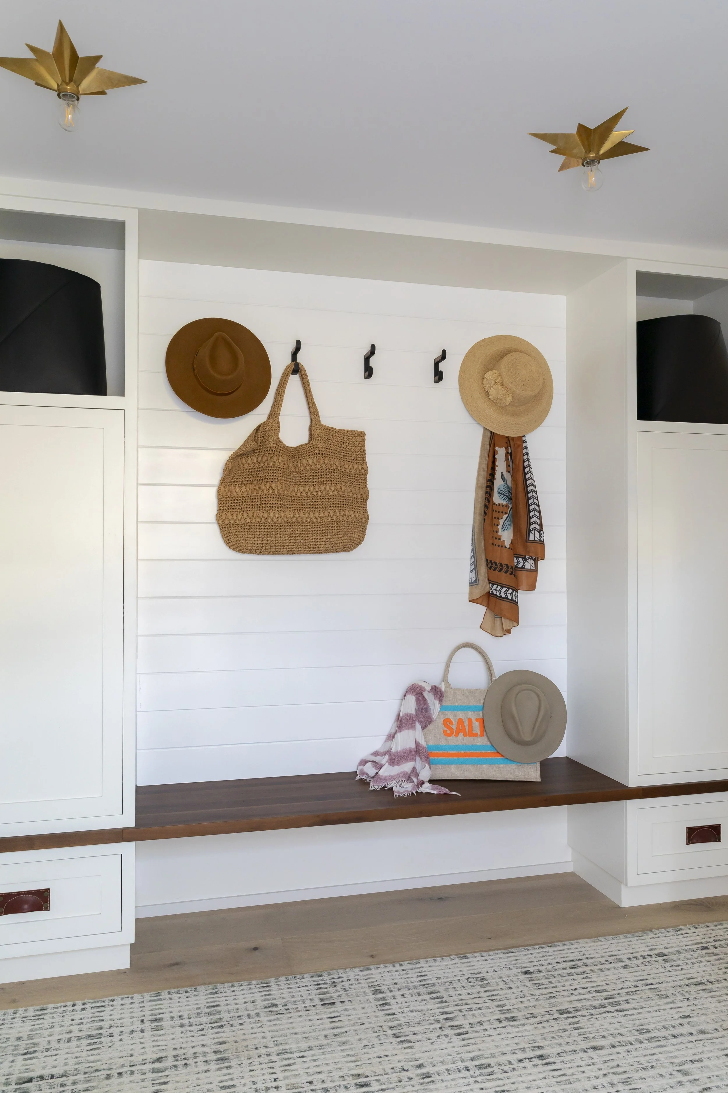 Solana Beach, CA entryway and mudroom design featuring custom built-in cabinetry, a bench with shiplap backdrop, and functional coastal-inspired styling by Anne Flynn Designs.