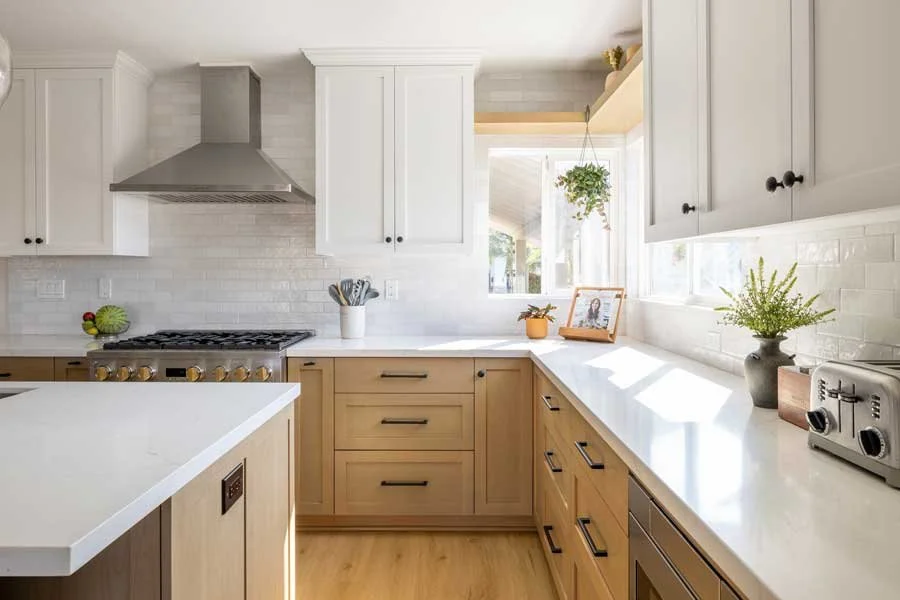 San Diego, CA kitchen design featuring custom wood cabinetry, white quartz countertops, classic subway tile, and bright transitional styling by Anne Flynn Designs.