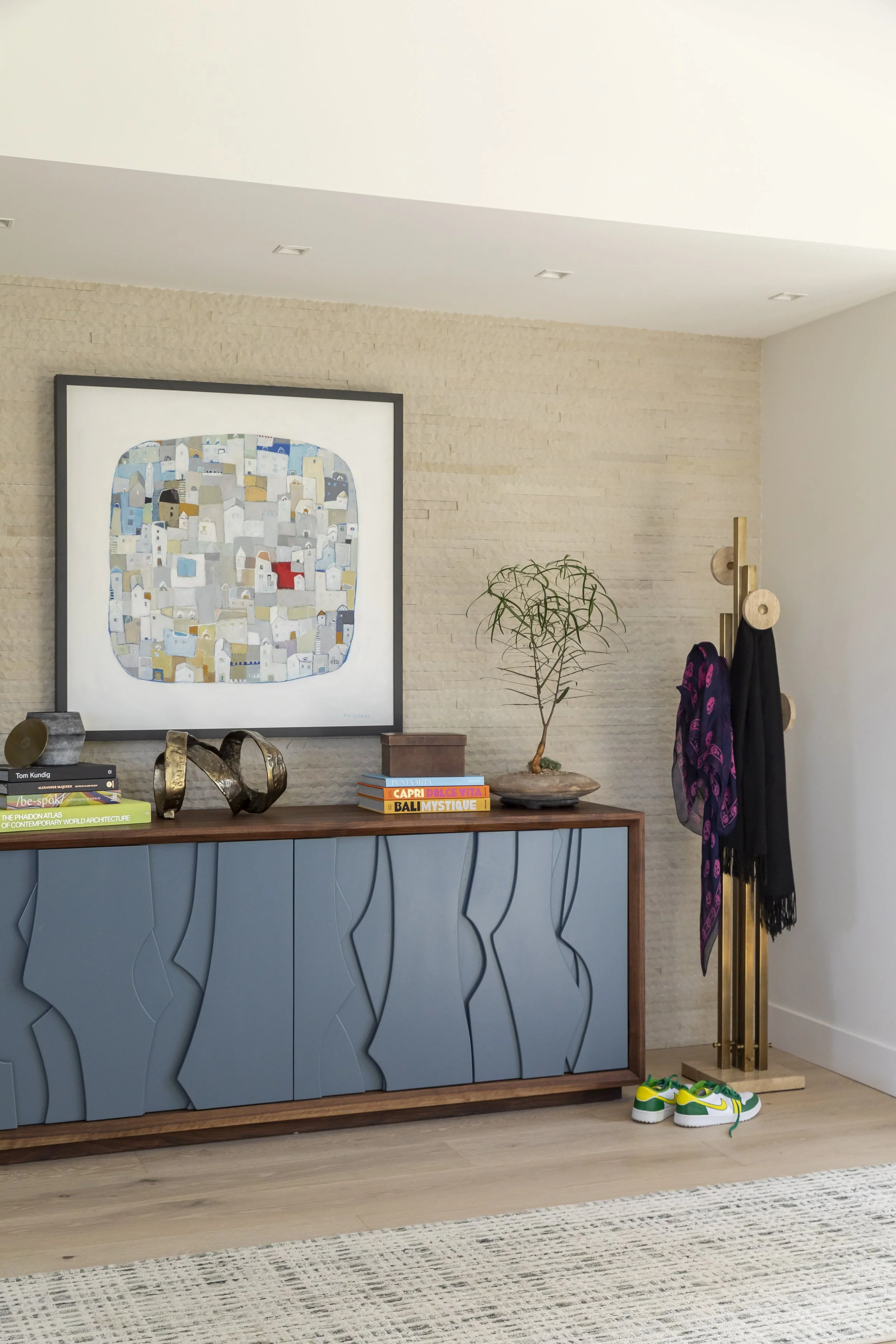 Solana Beach, CA entryway design featuring a custom sculptural credenza, curated artwork, and refined modern styling by Anne Flynn Designs.