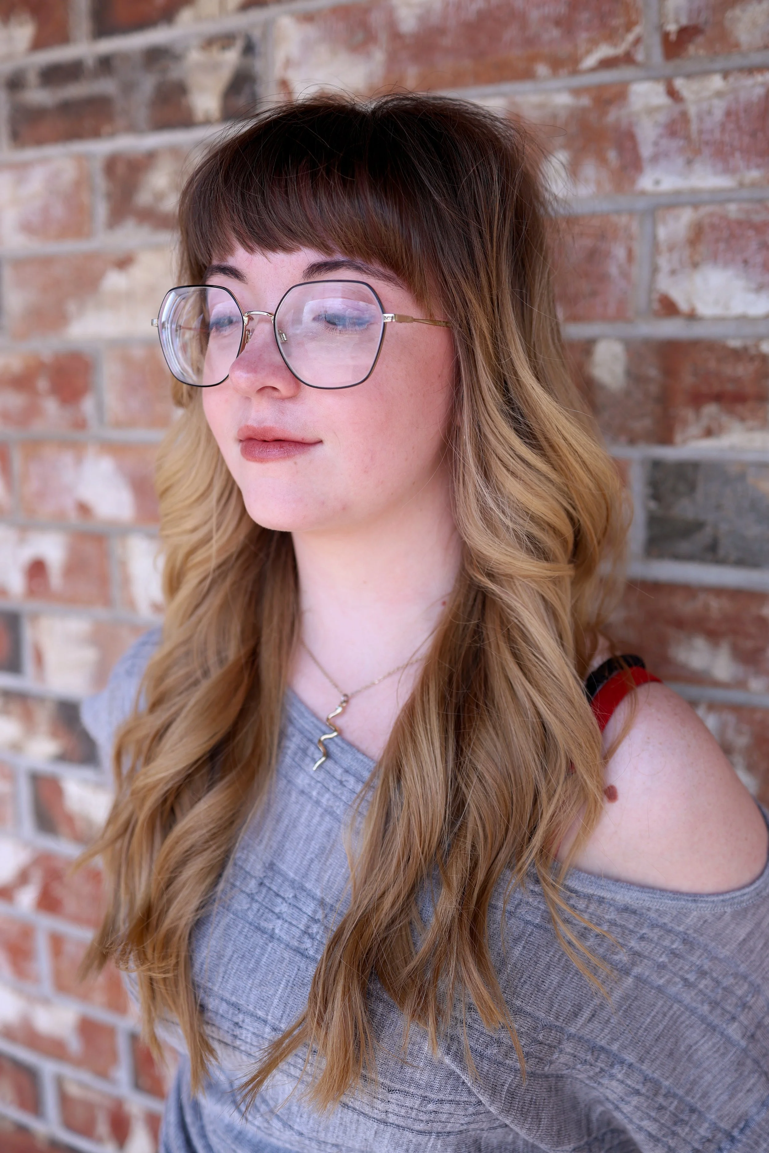 woman with a long layered shag haircut and modern fringe bangs